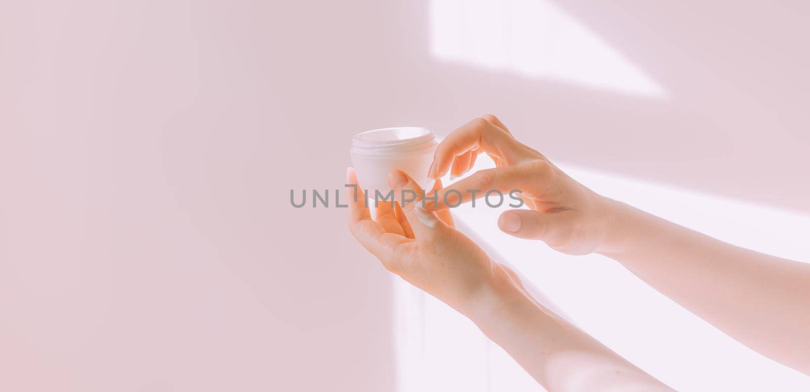 Women's hands hold a cosmetic copy space cream . An article about care cosmetics. Hand cream. Face cream.