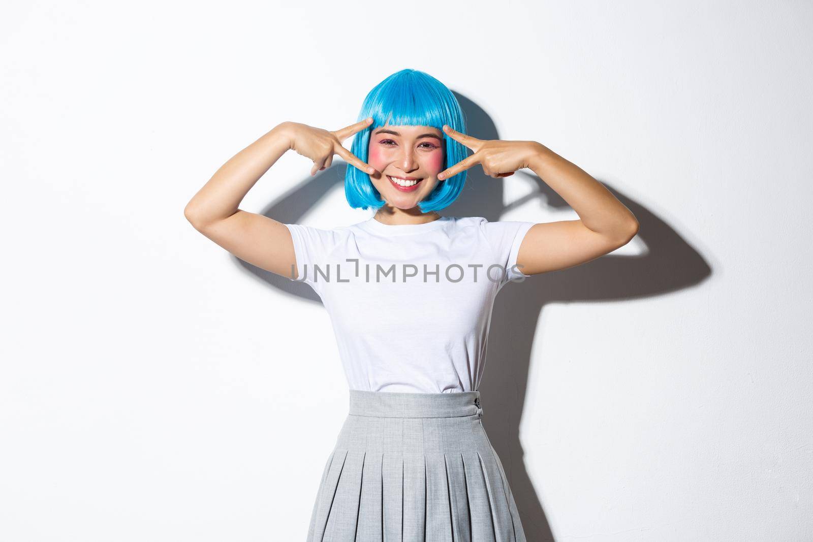 Enthusiastic cute asain girl enjoying party, celebrating halloween in glamour costume, wearing wig with schoolgirl uniform, showing peace gestures by Benzoix
