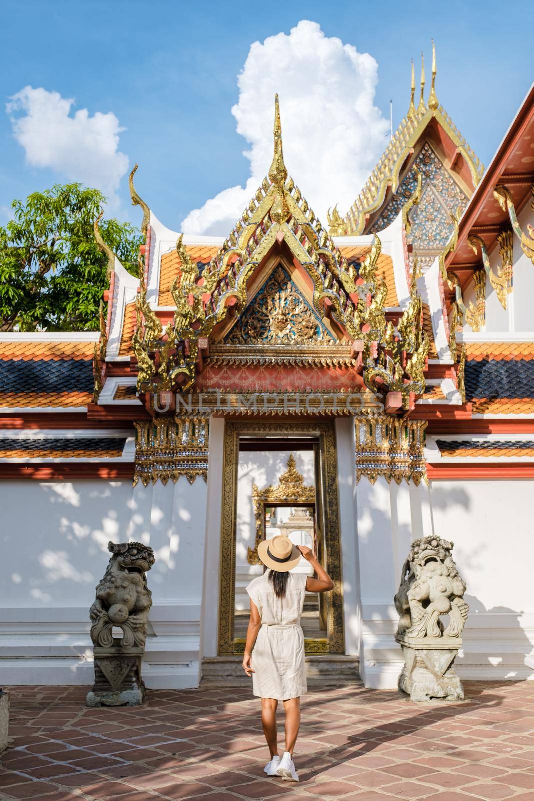 Wat Pho temple in Bangkok Thailand, The reclining temple in Bangkok. Beautiful Buddhist temple on a bright sunny day. Asian woman visiting Wat Pho temple