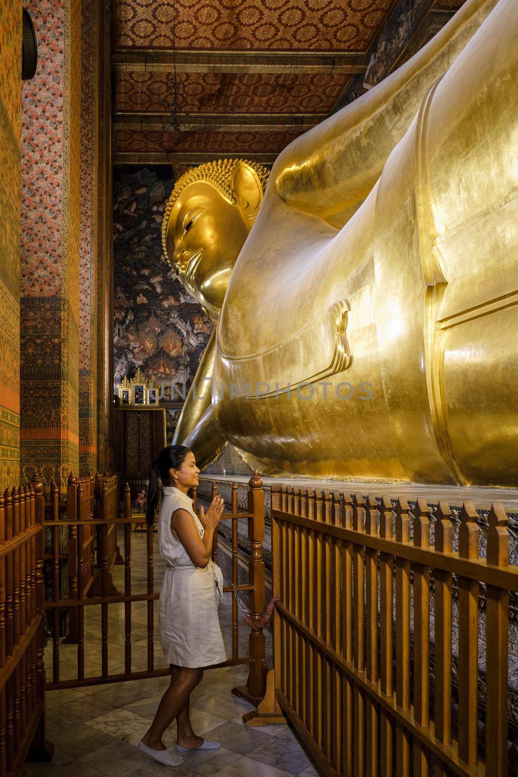 Wat Pho temple in Bangkok Thailand, The reclining temple in Bangkok. Beautiful Buddhist temple on a bright sunny day. Asian woman visiting Wat Pho temple