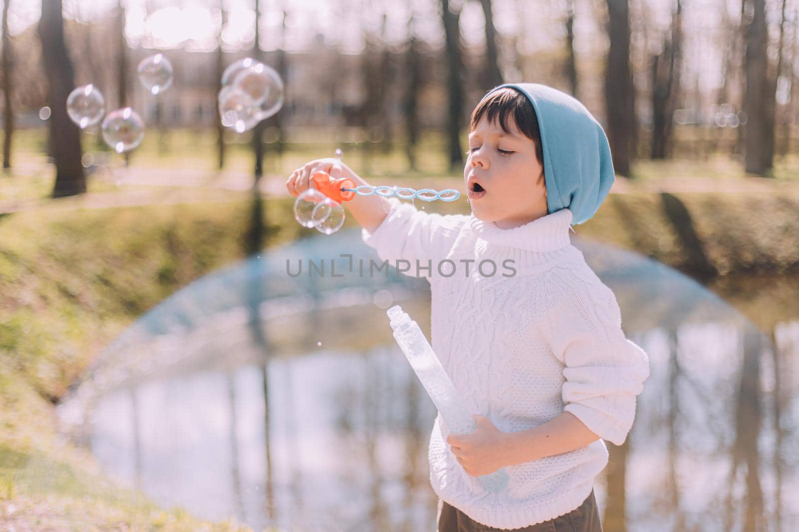 The boy blows soap bubbles lifestyle . Children's entertainment. Children's portrait. Article about children's leisure