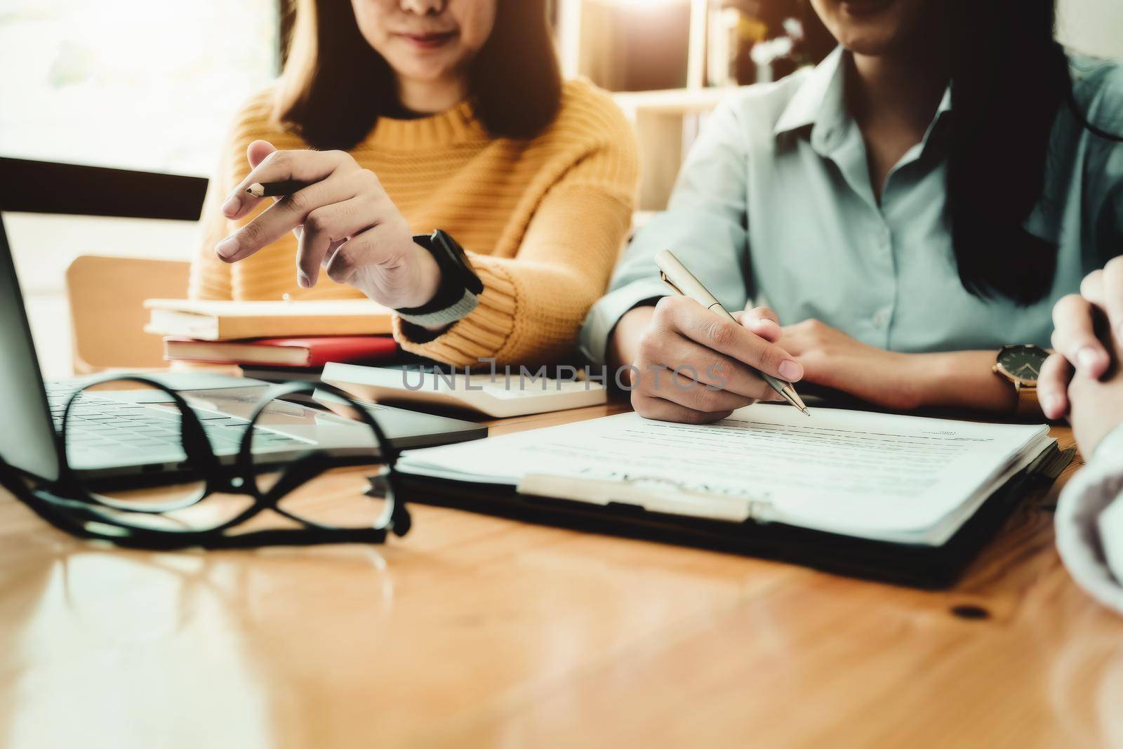 Business owner holding a pen to read the conditions to enter into a joint venture contract with a partner company. by Manastrong