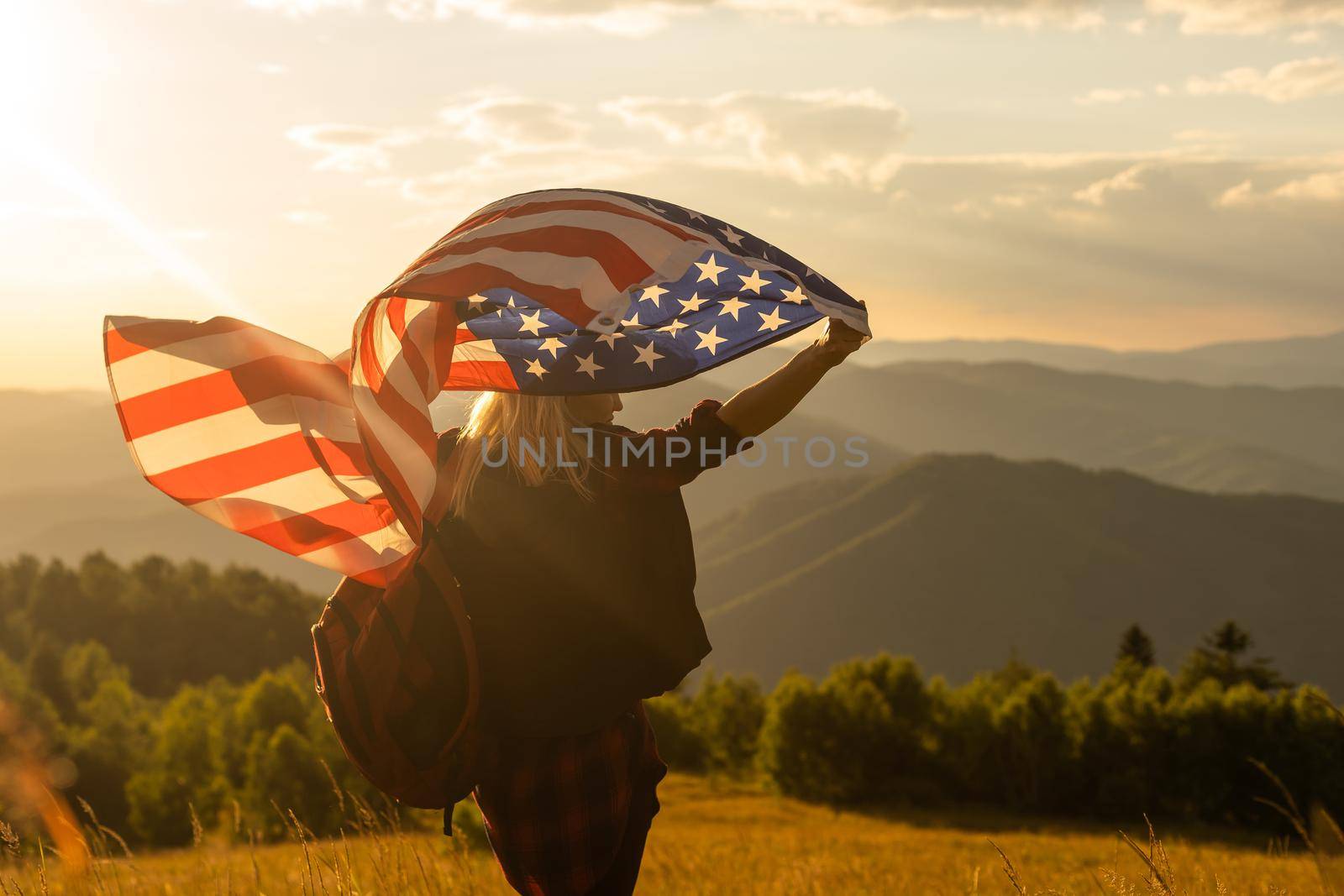 young beautiful woman holding USA flag. by Andelov13