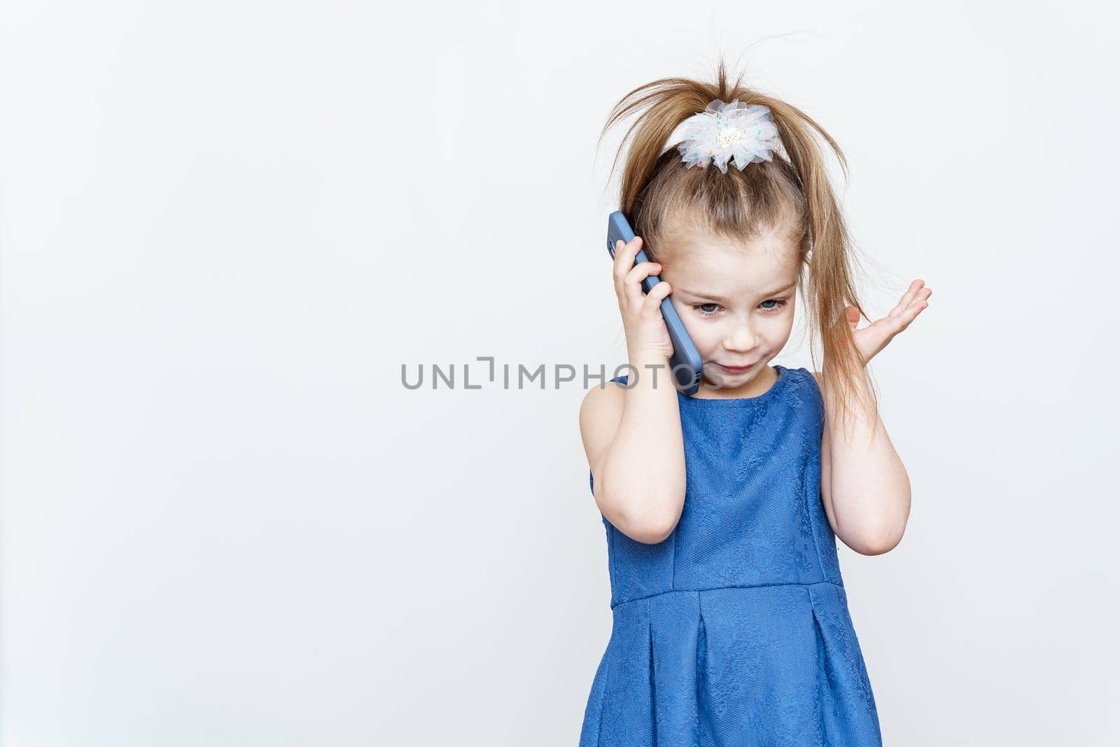 kid posing in the studio with a smartphone by Lena_Ogurtsova