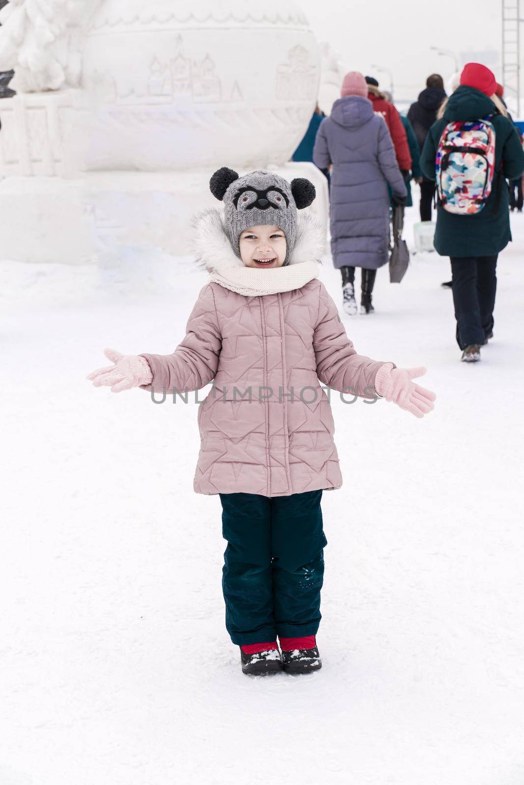 playful child girl happy in snow town on winter day by Lena_Ogurtsova