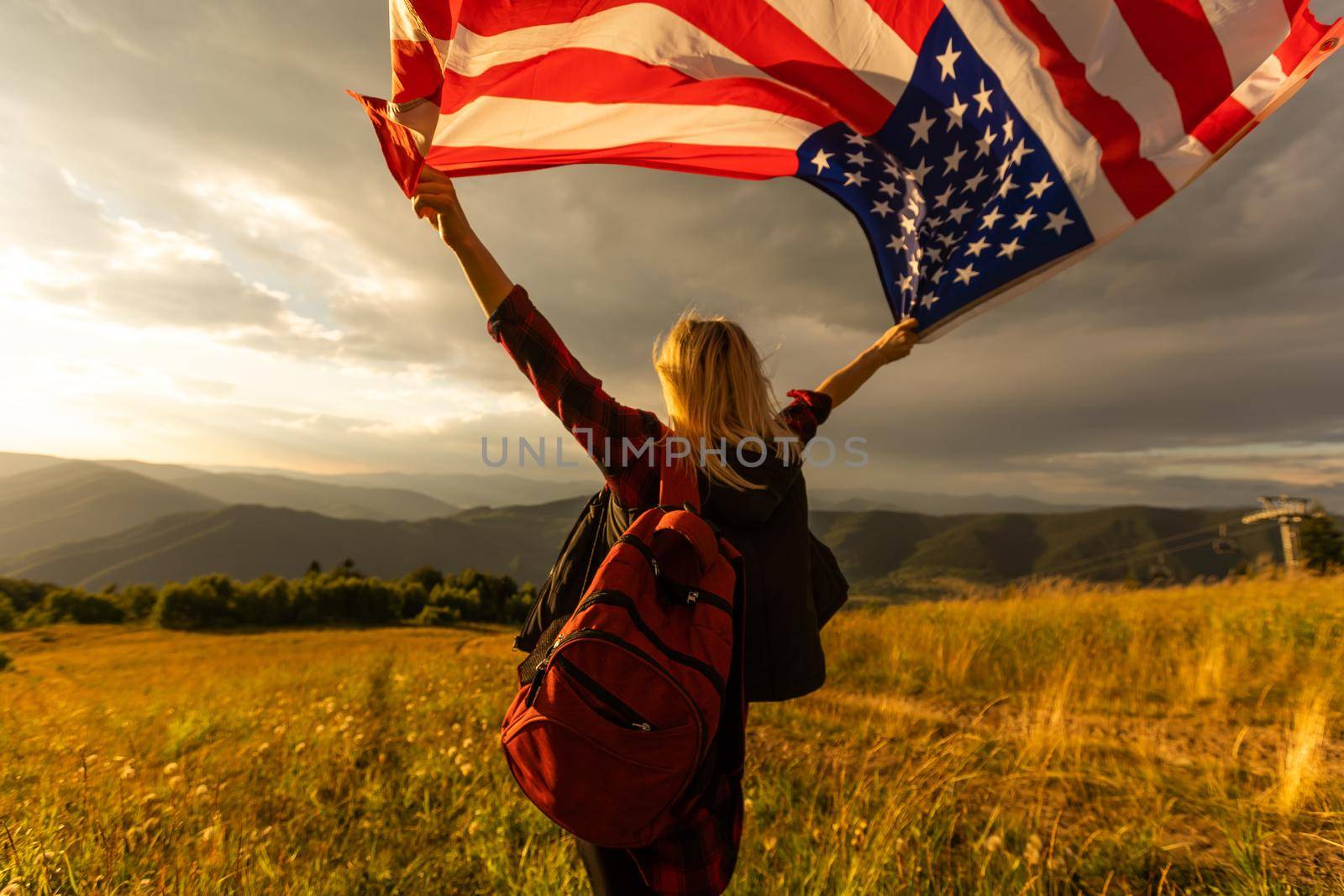 young beautiful woman holding USA flag