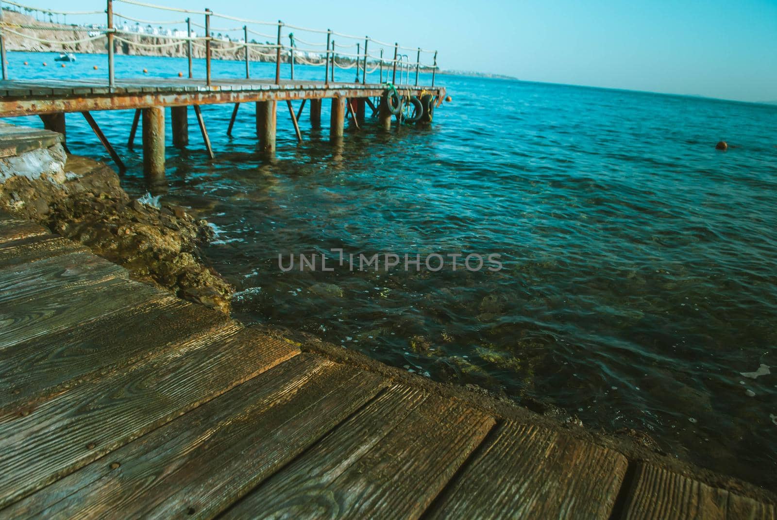 wooden pier in the sea with waves. High quality photo