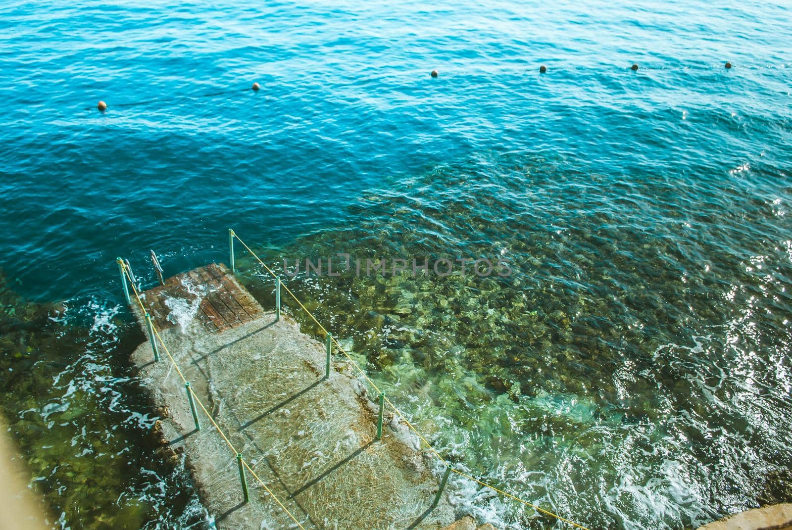 wooden pier in the sea with waves. High quality photo