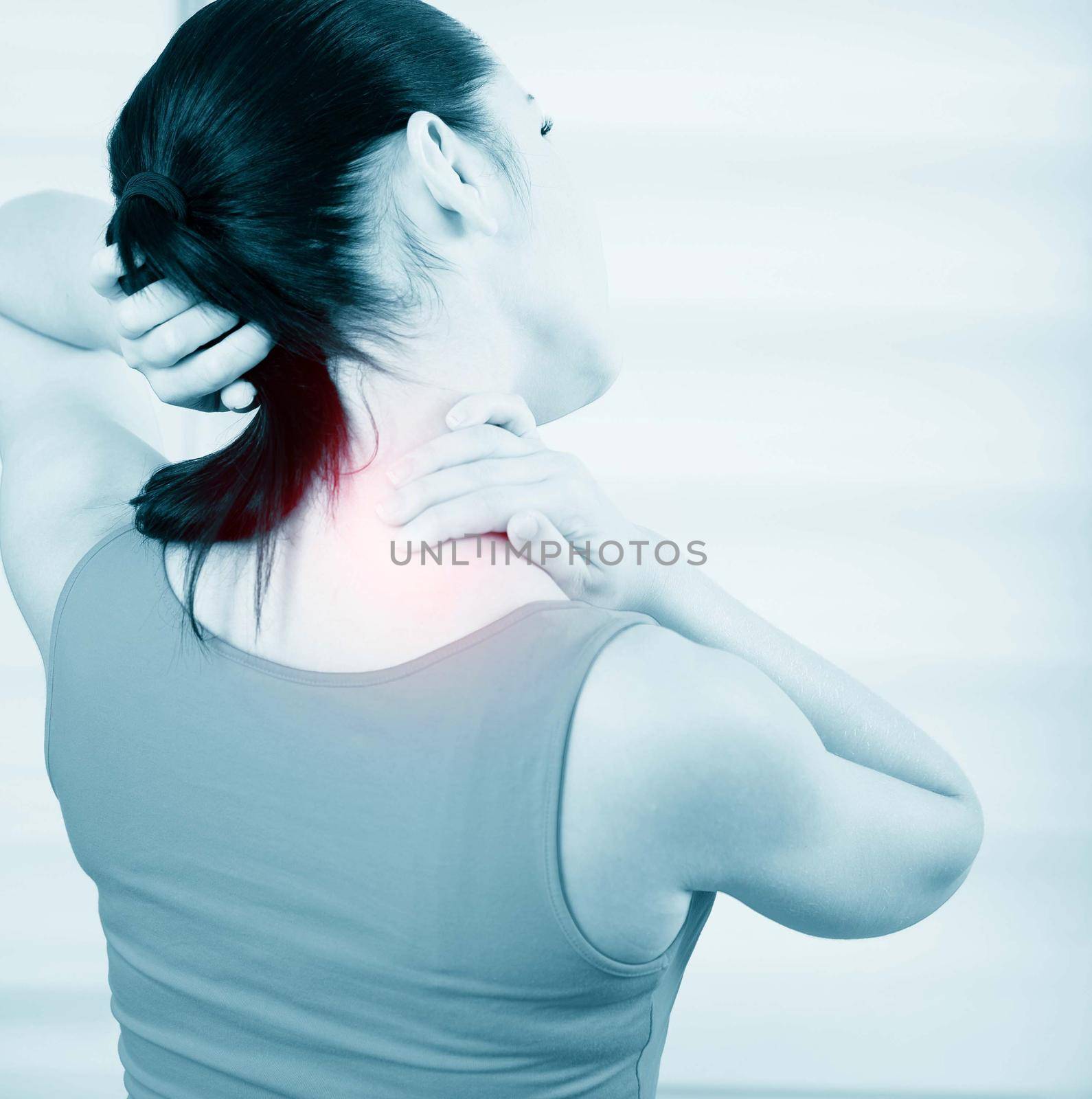 young brunette woman with a pain in the neck