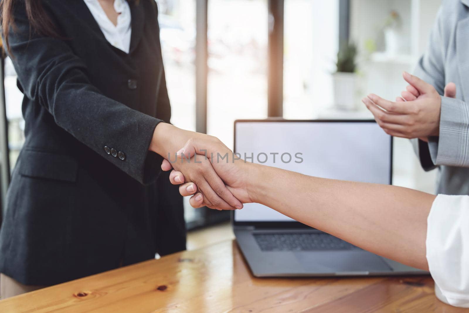 business merger, Asian businessman shake hands at the conference room with showcase their collaboration to strengthen their marketing efforts by Manastrong