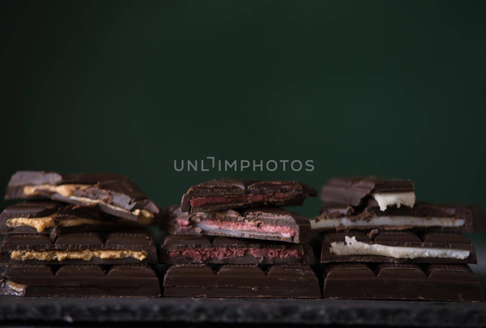 variety of homemade chocolate with different fillings. dark food photo