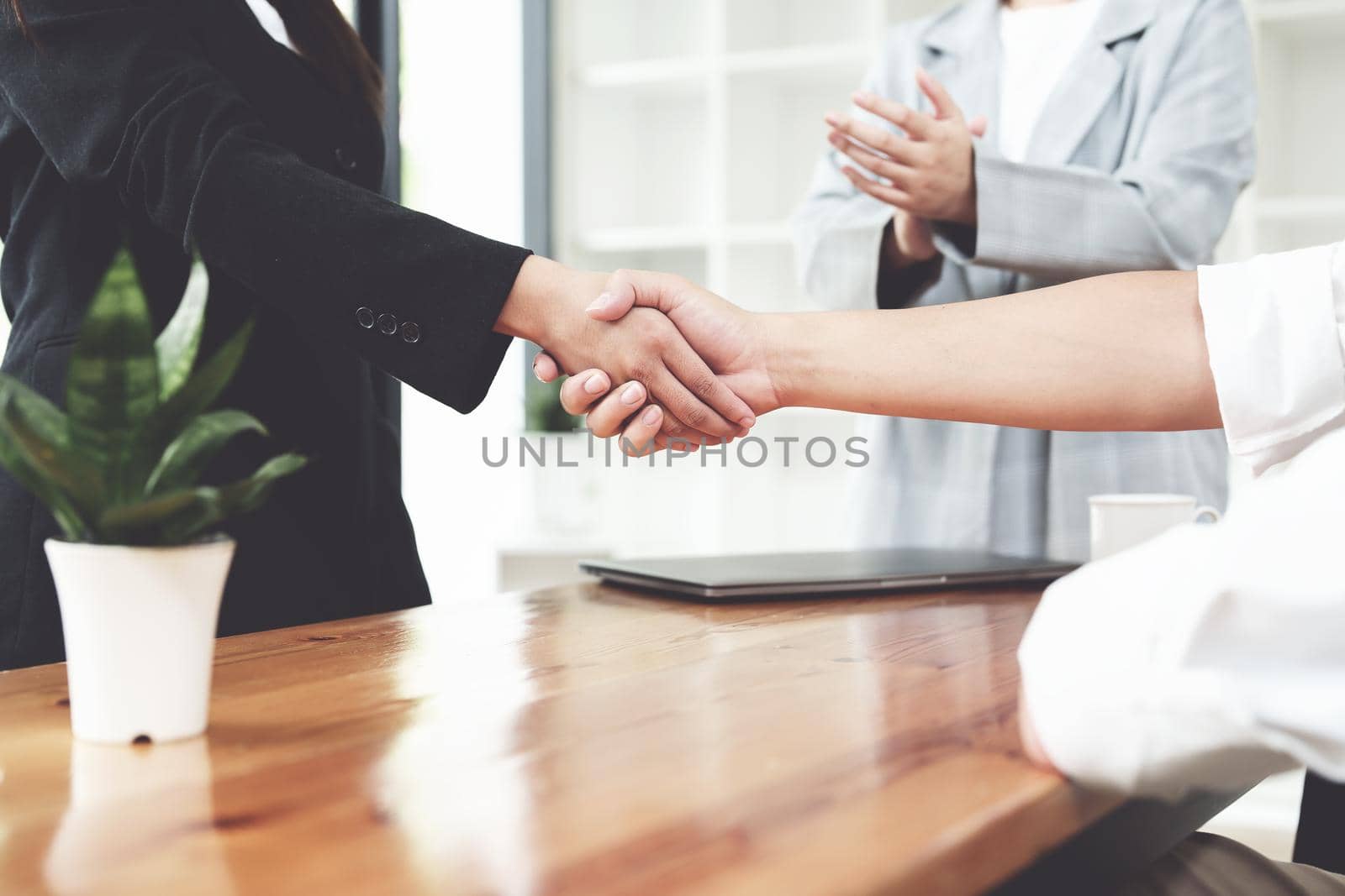 business merger, Asian businessman shake hands at the conference room with showcase their collaboration to strengthen their marketing efforts by Manastrong