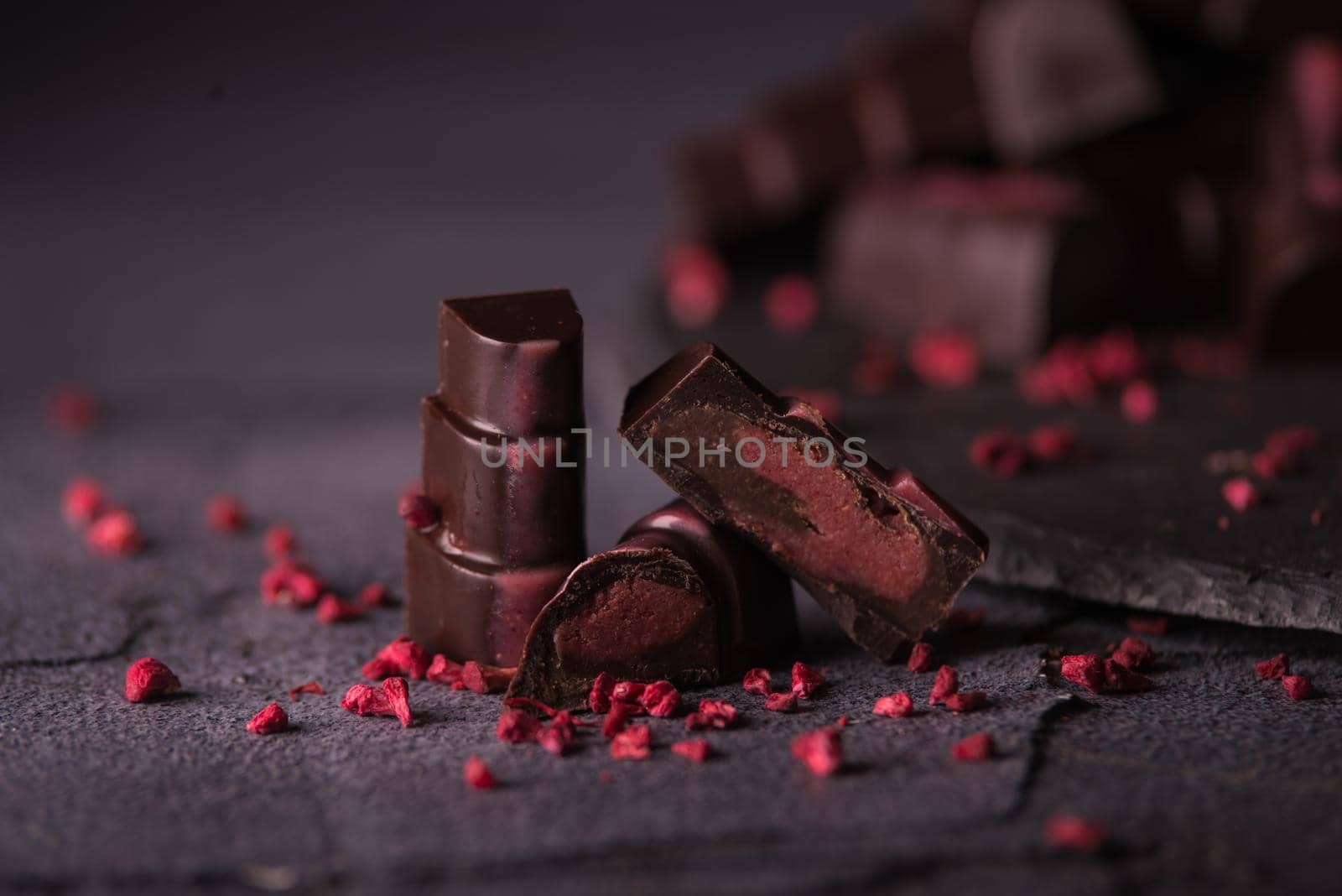 chocolate homemade candies with raspberry fillings. dark food photo