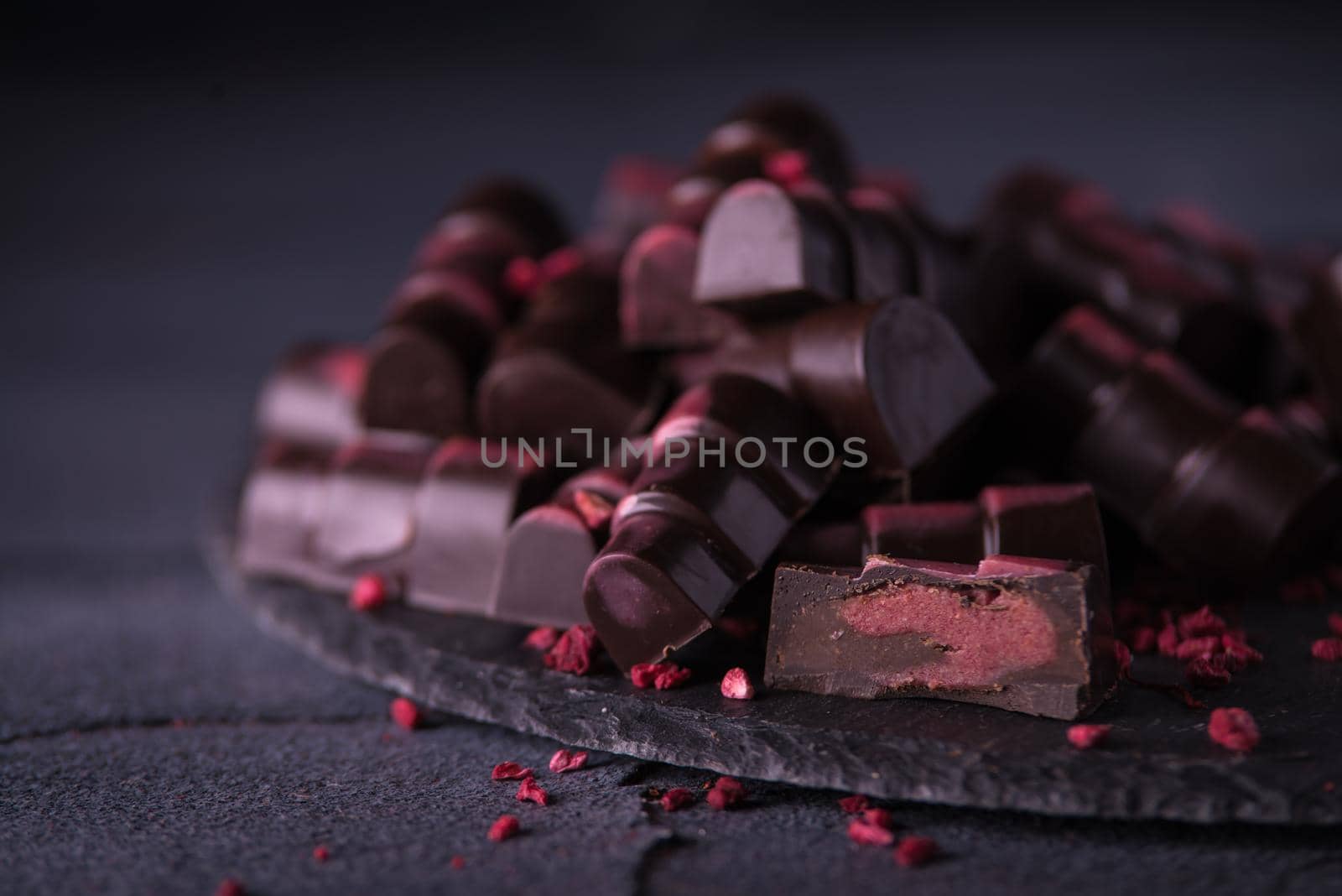 chocolate homemade candies with raspberry fillings. dark food photo