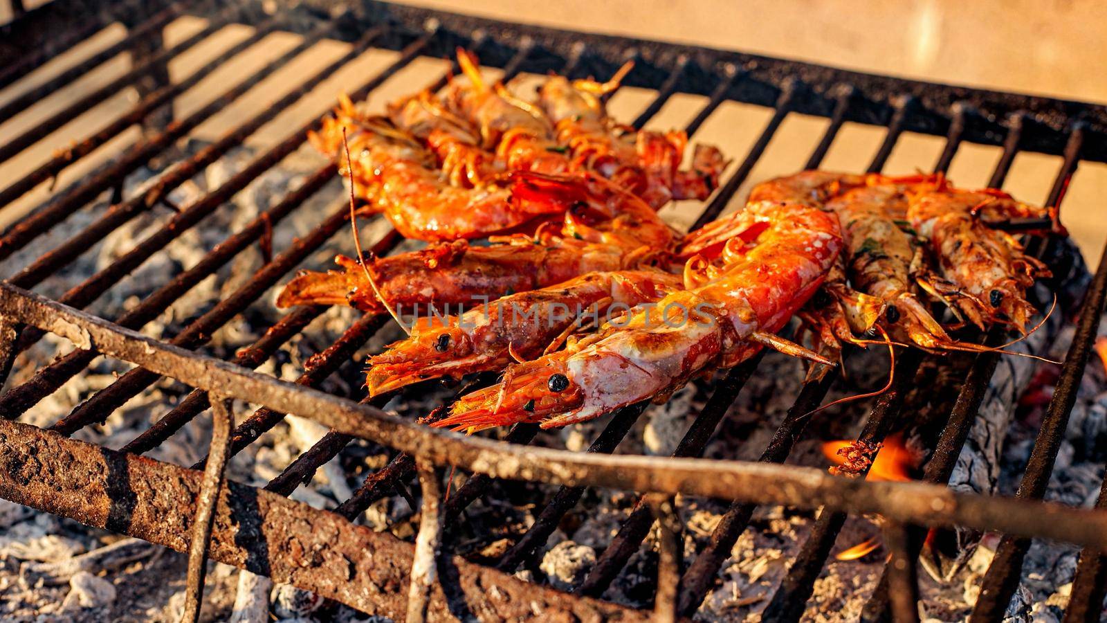 Grilled shrimp (Giant freshwater prawn) grilling with charcoal. Grilled shrimp on a grill with charcoal grill. Close-up of shrimps being fried in oil pan