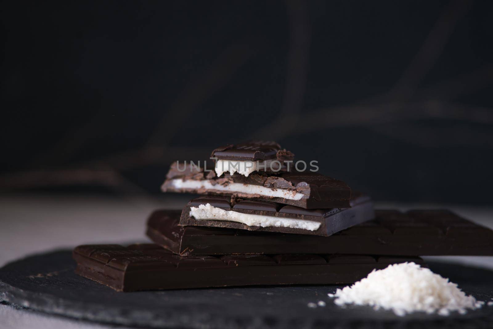 chocolate homemade bars with coconut fillings. dark food photo
