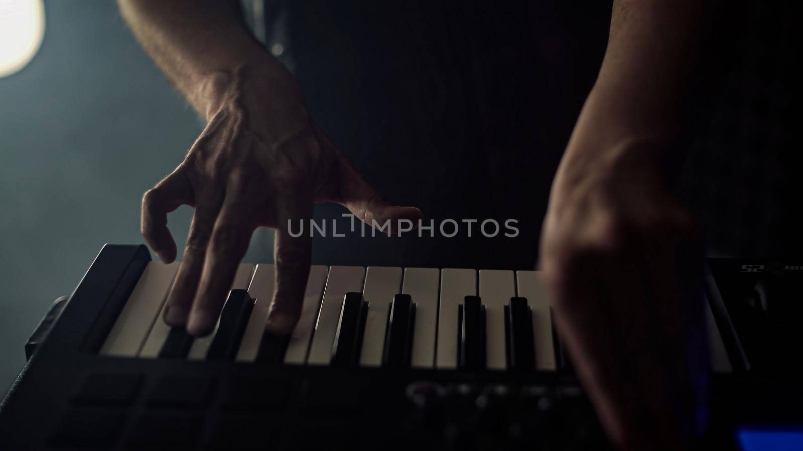 Man plays music using a sampler professional music equipment by pippocarlot