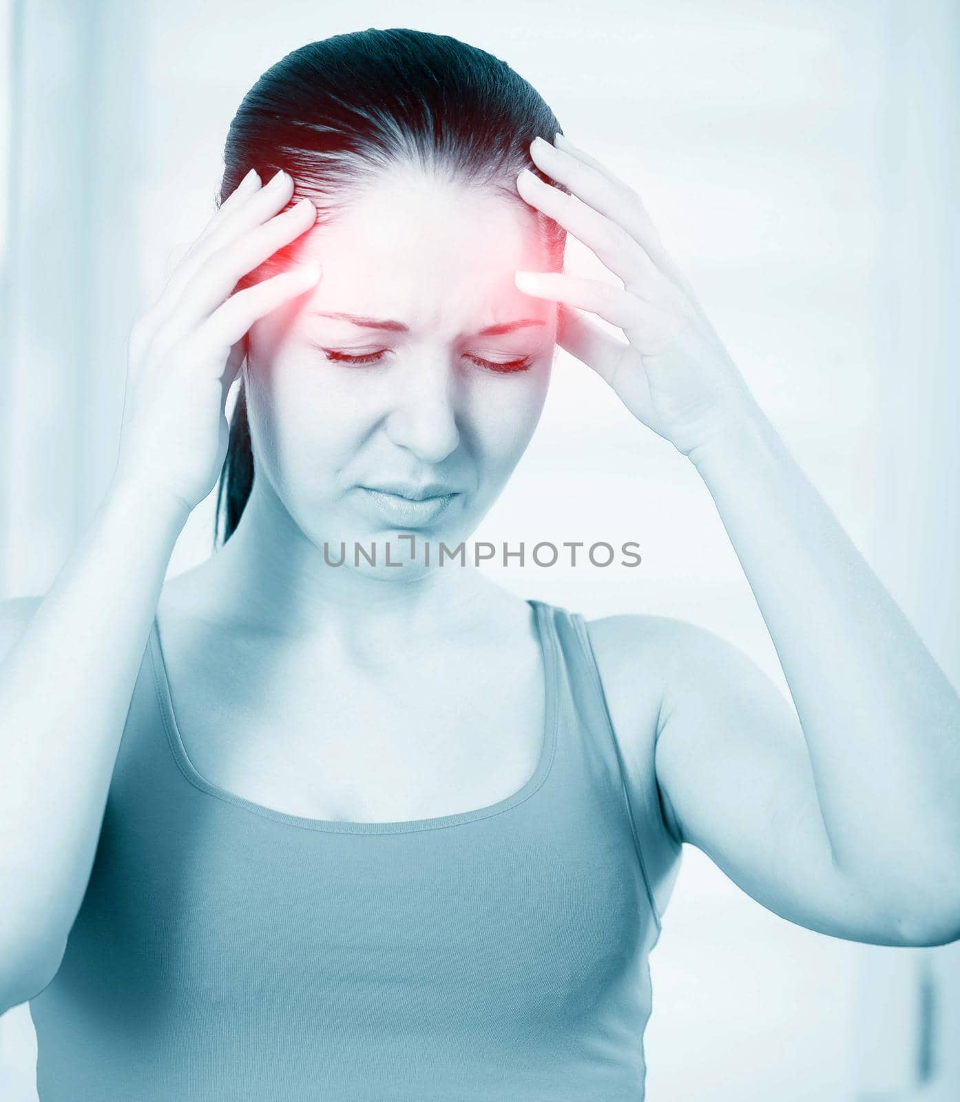 A young woman with headache holding head