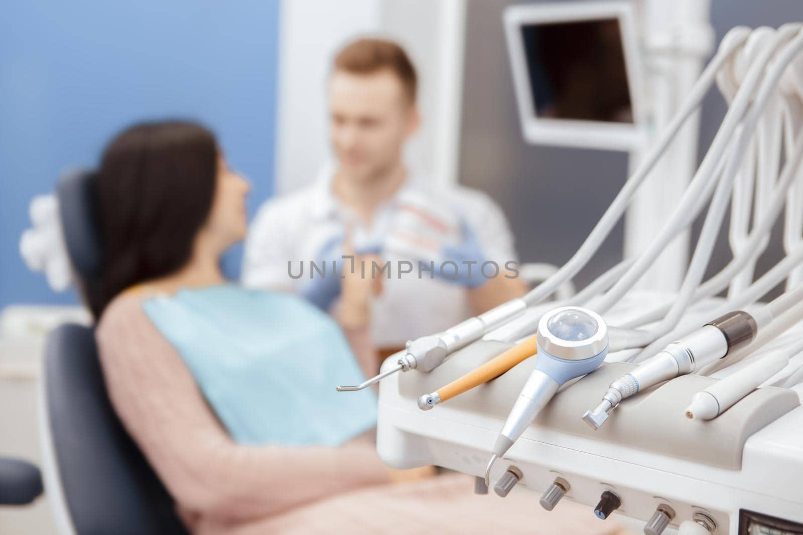 Modern dentistry. Selective focus on dentistry tools professional dentist talking to his patient on the background copyspace client service help medicine healthcare dental procedures people profession