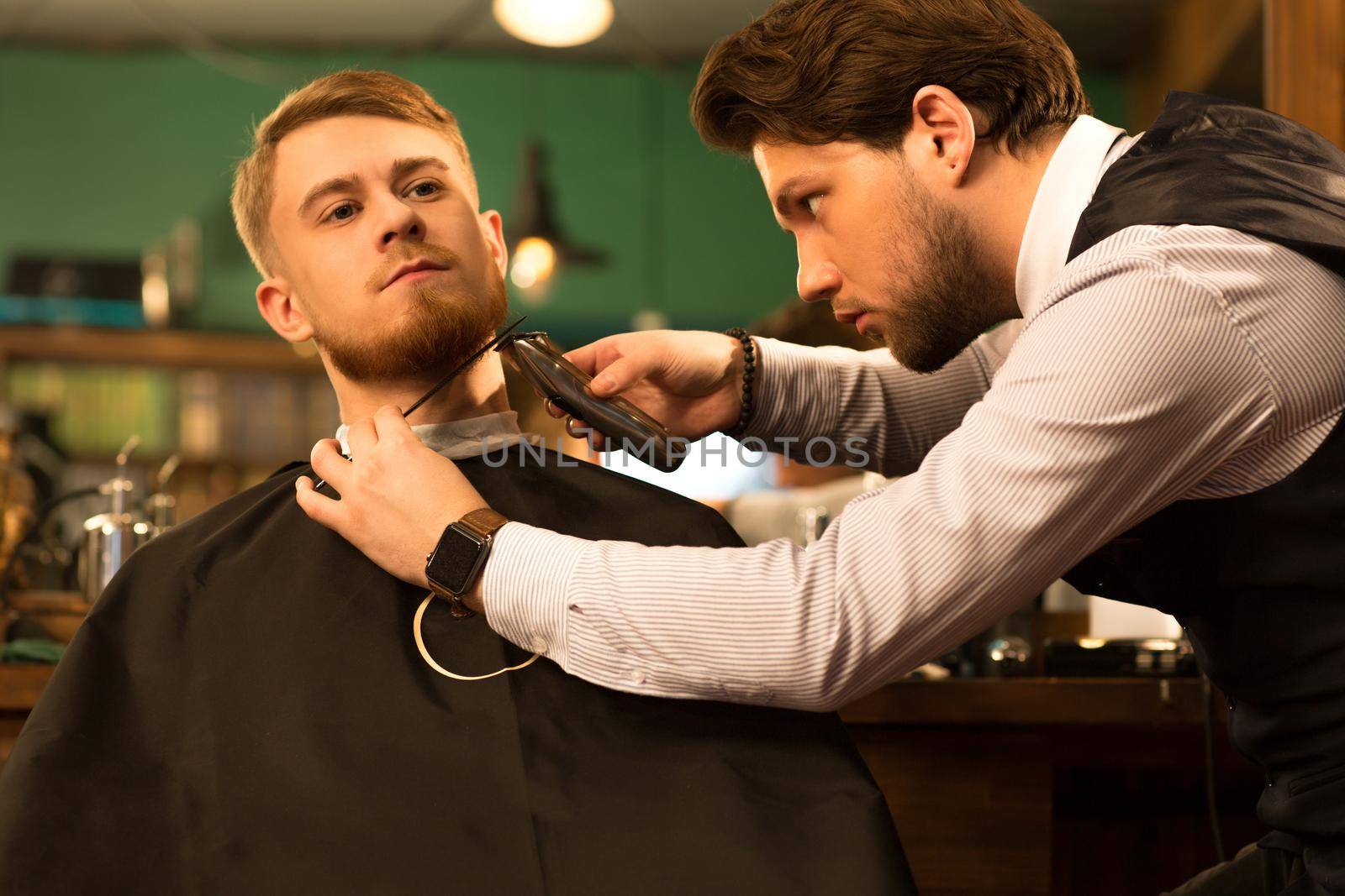 Handsome young bearded man at the barbershop by MAD_Production