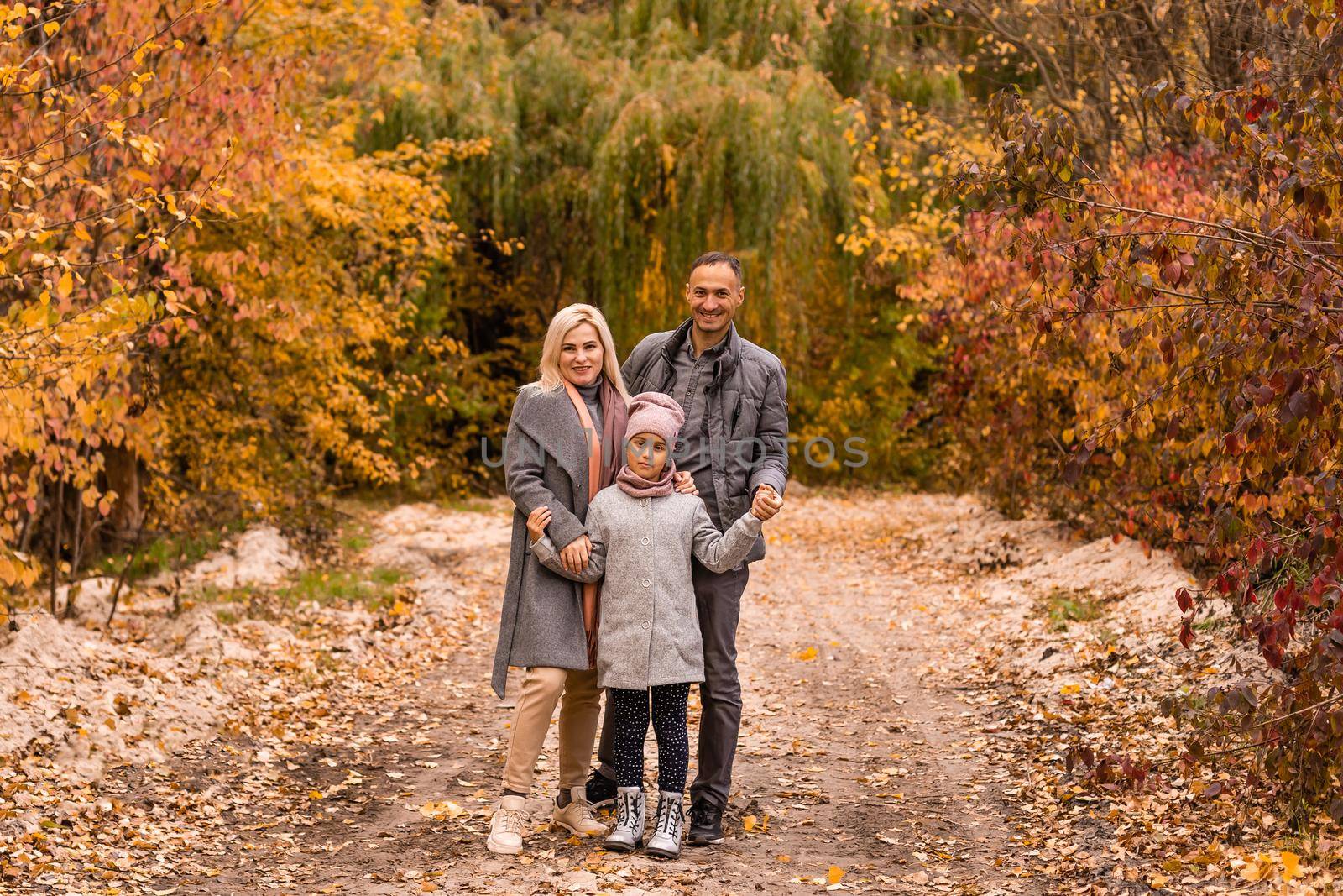 Portrait of family during the autumn.