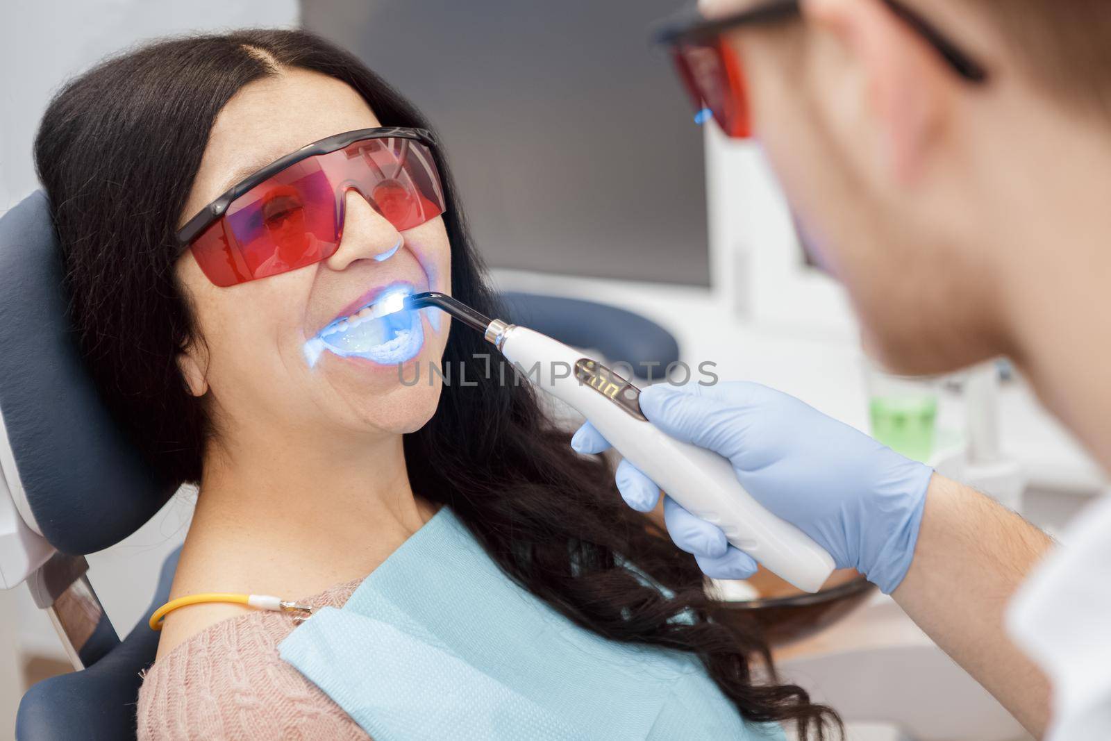 Dental filling with UV lamp for a senior female patient by MAD_Production