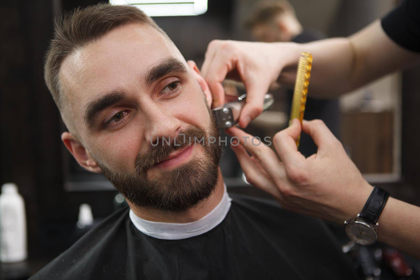 Man getting beard cut by professional barber by MAD_Production