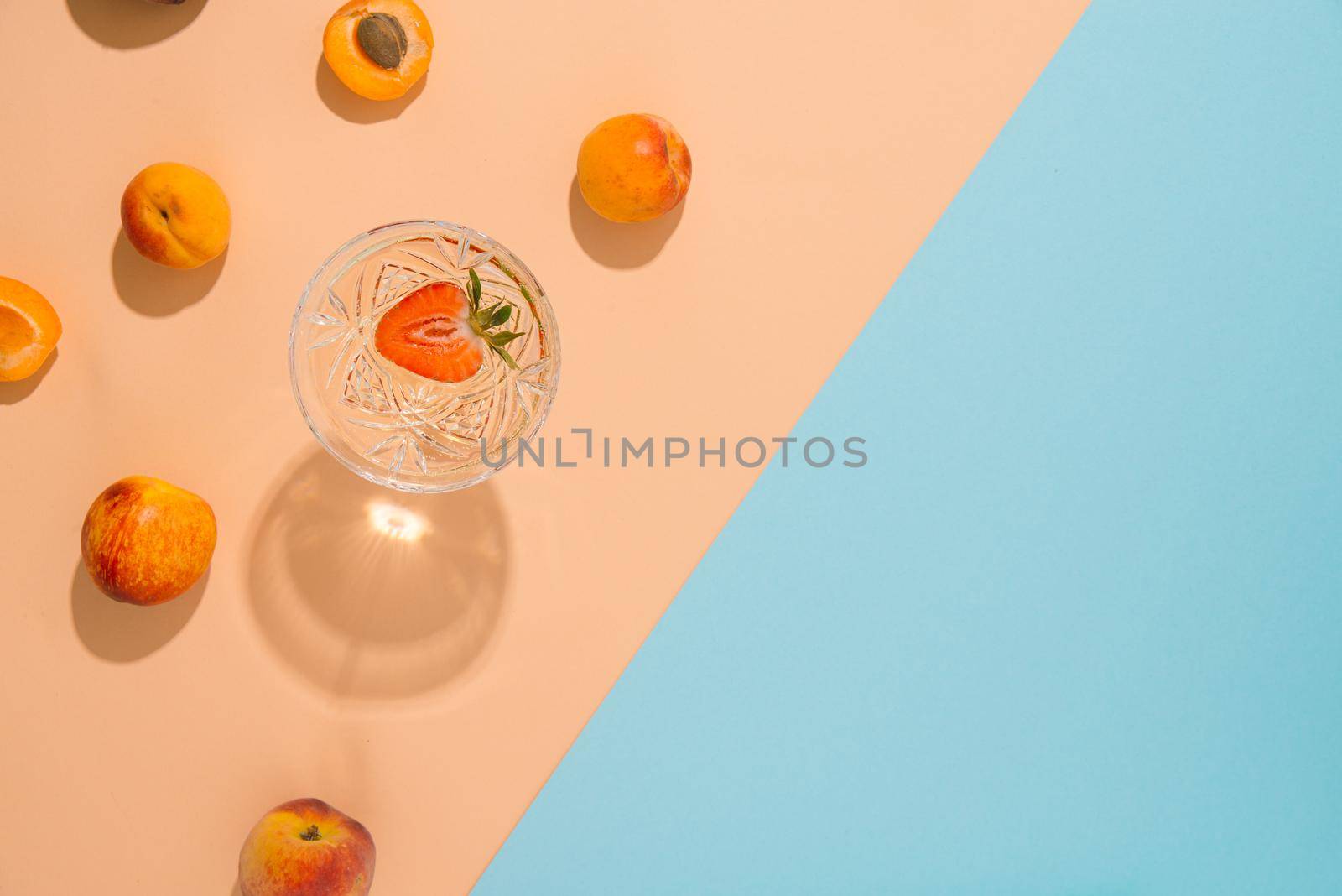 coctail an ripe summer abricot on pastel and blue background. creative summer concept