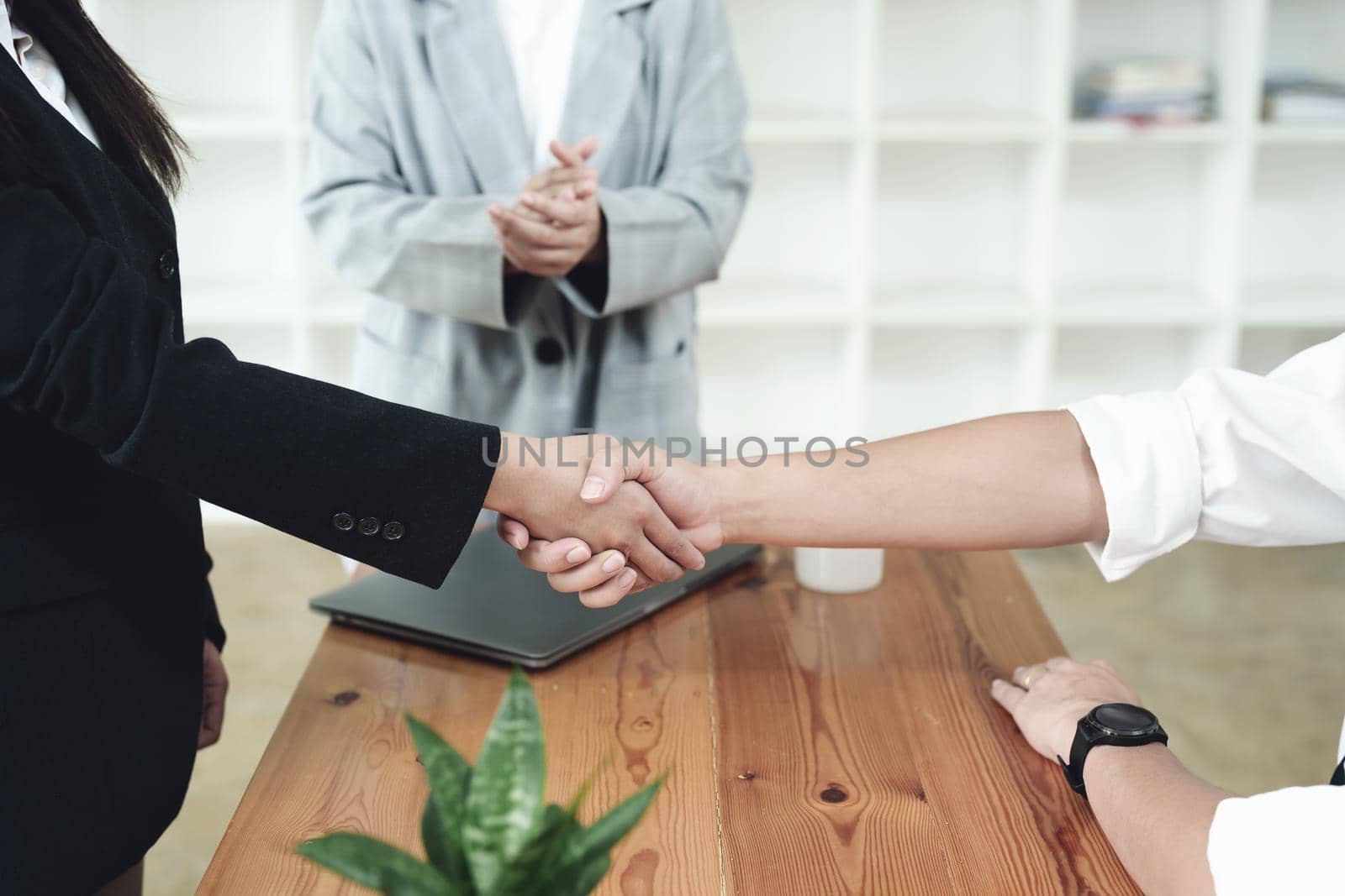 business merger, Asian businessman shake hands at the conference room with showcase their collaboration to strengthen their marketing efforts by Manastrong