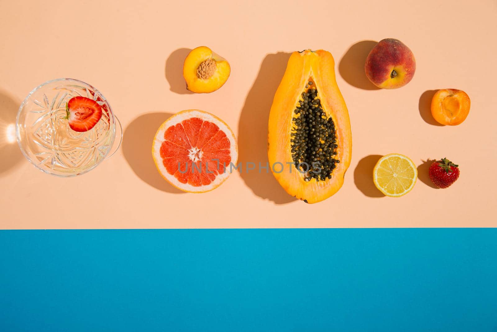 tropical summer fruits on pastel and blue background. creative arrangement