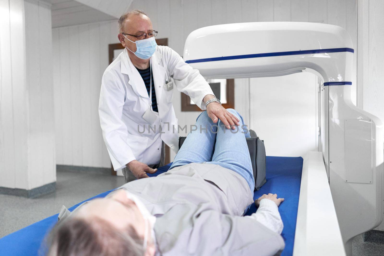 Doctor preparing a patient for x-ray tests by WesternExoticStockers