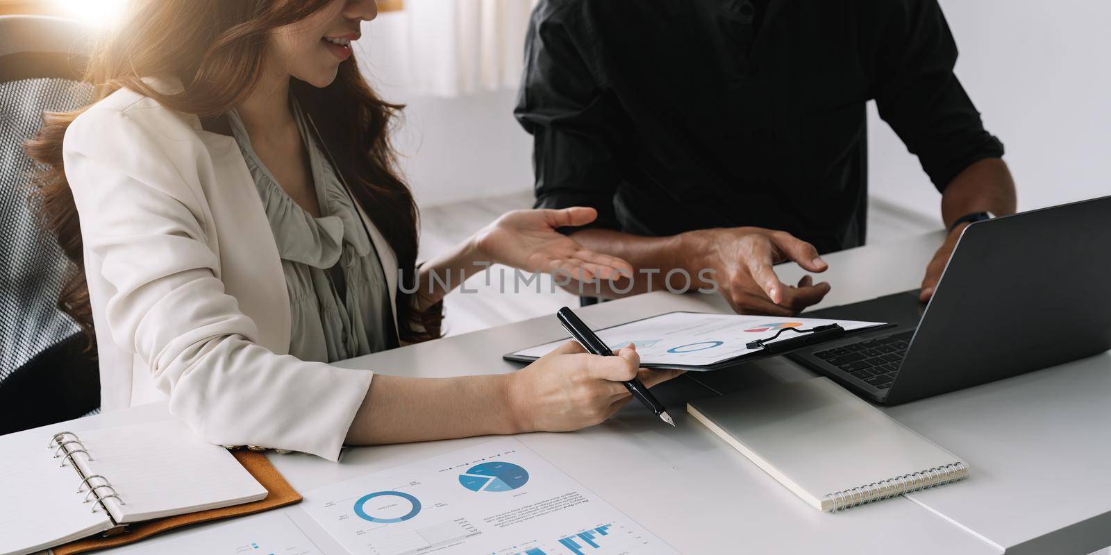 Business team finance or bookkeeper working with a calculator to calculate business data summary report, accountancy document and laptop computer at the office, business meeting concept.