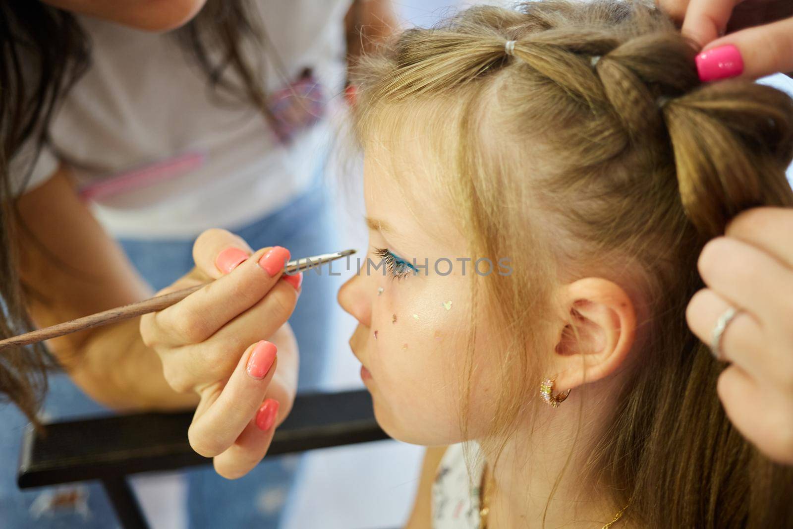 Children make up. Glitter makeup. Sparkles on cheek. by sarymsakov