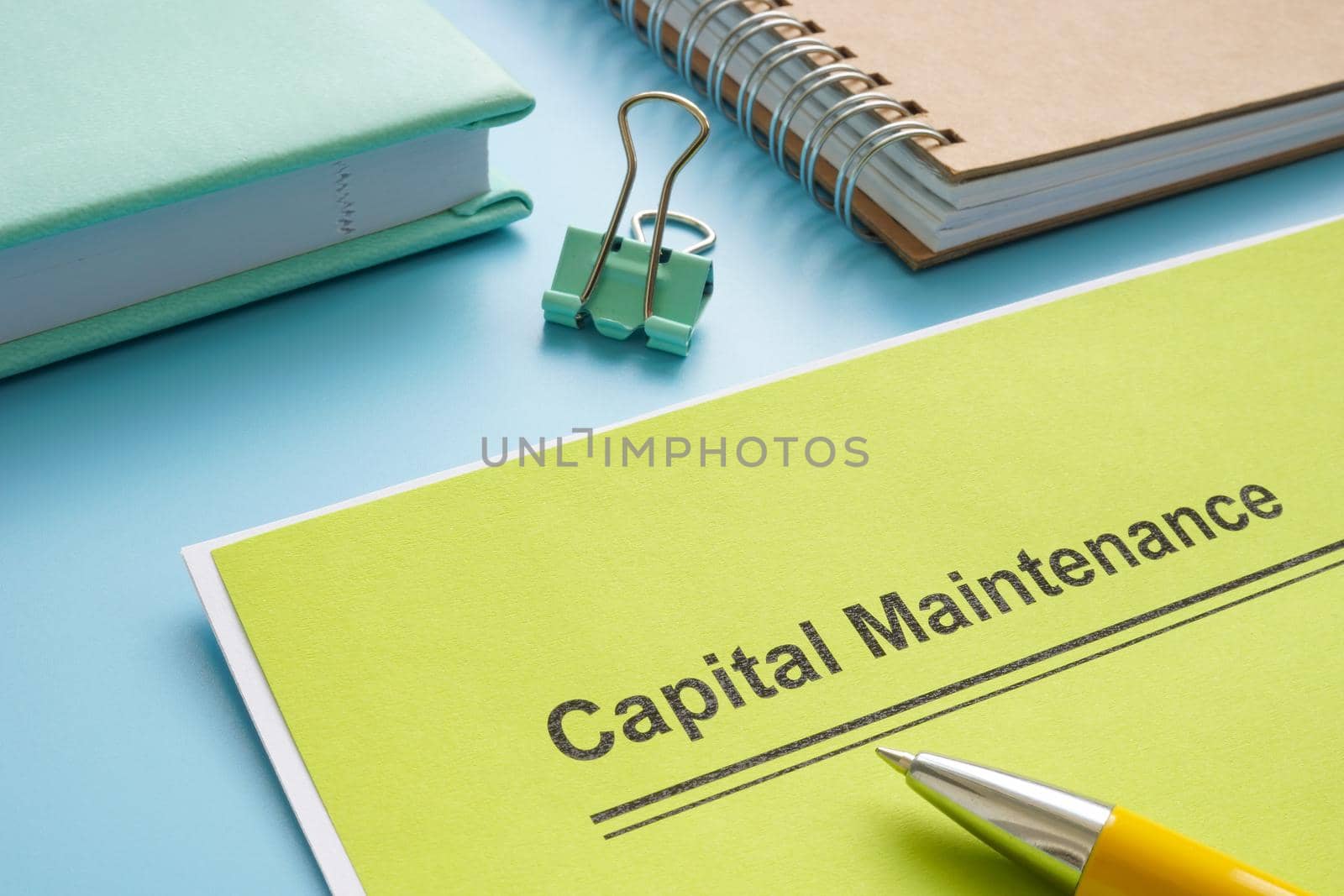 Papers about capital maintenance near the notepad. by designer491