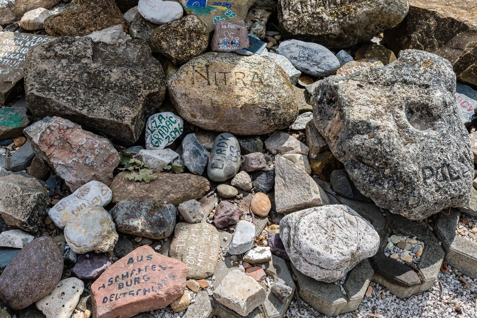 Ratiskovice, Czech Republic - July 7 - The mythical hill of Naklo near Ratiskovice. Stones with inscriptions from places from different parts of the world in a sweat place under the cross