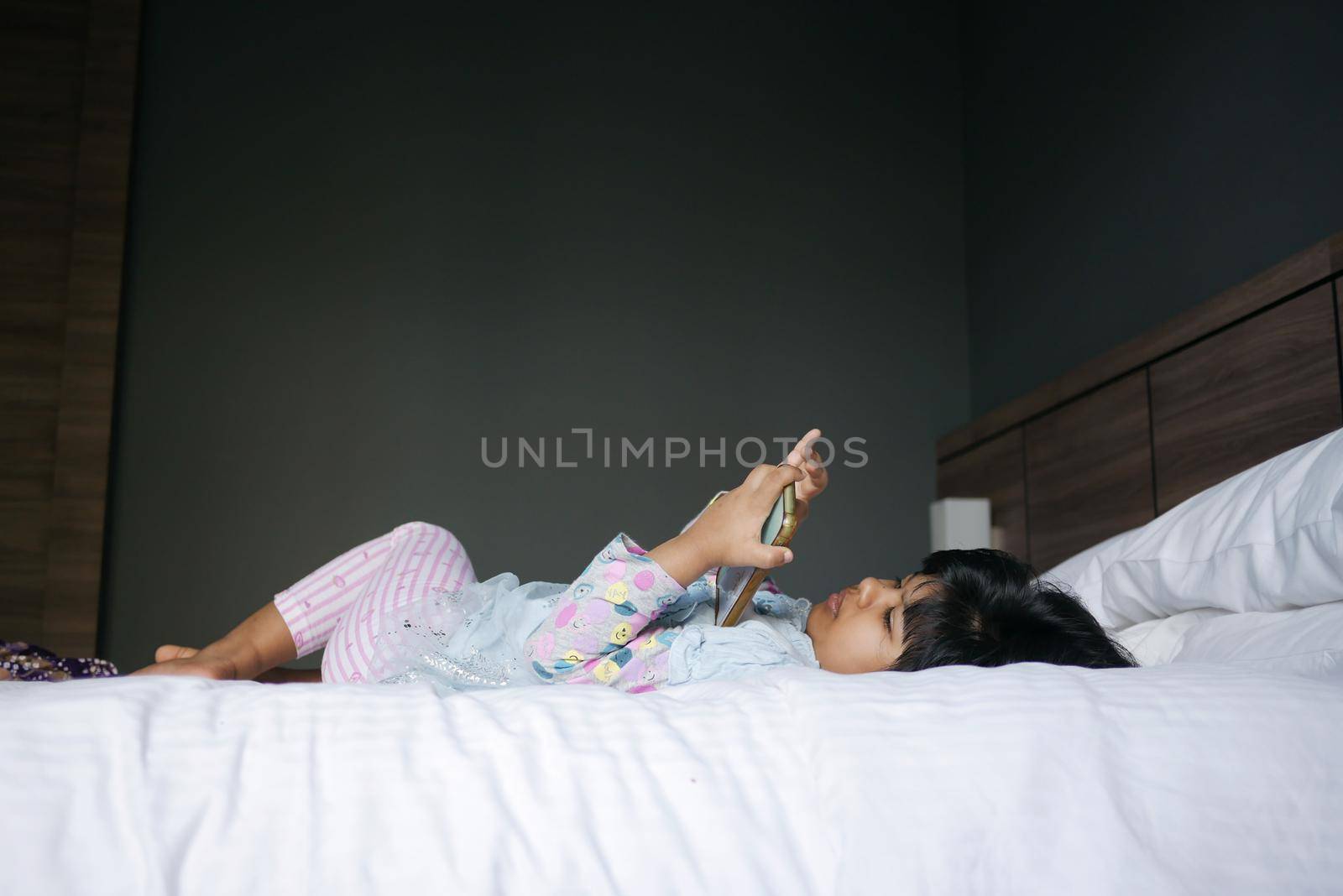 Child girl watching cartoon on smart phone ,