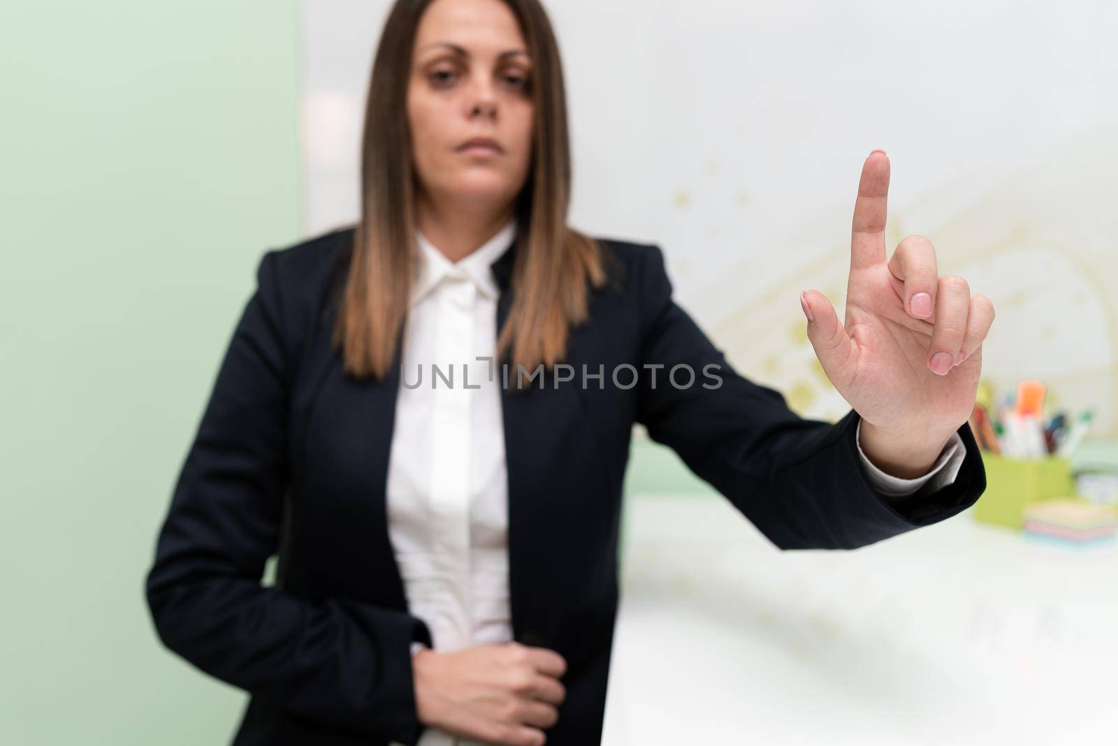 Businesswoman Pointing With One Finger On Important Message.