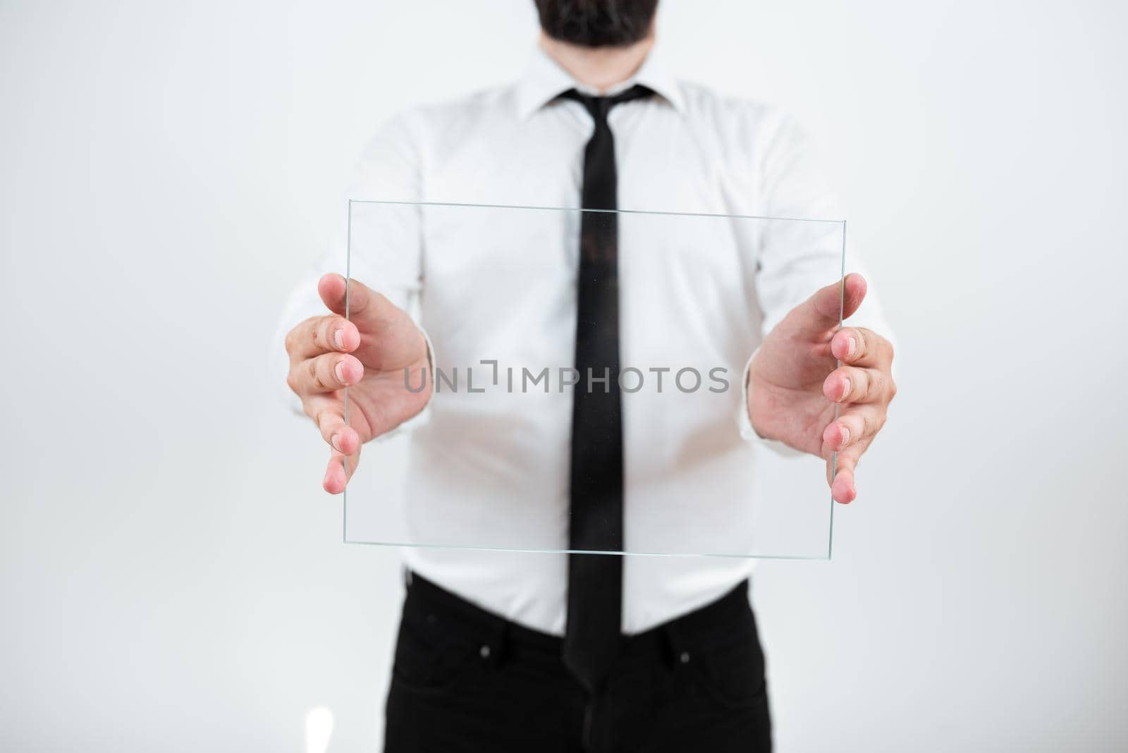 Male Corporate Holding Transparent Glass And Presenting Important Sales Data. Man Wearing Necktie Displaying New Ideas And Strategies For Achieving The Business Goals. by nialowwa