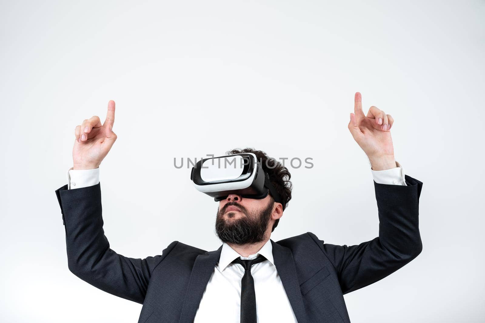 Man Wearing Vr Glasses And Pointing On Important Messages With Both Hands. Businessman Having Virtual Reality Eyeglasses And Showing Crutial Informations With Two Fingers. by nialowwa