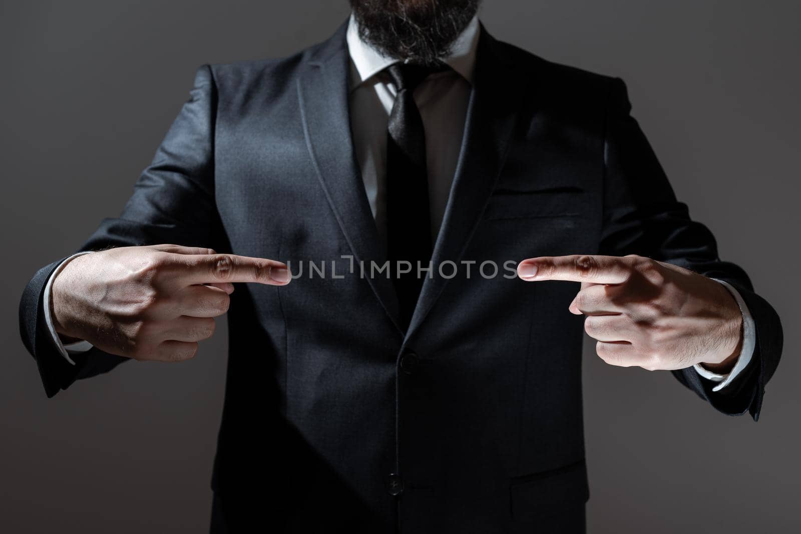 Businessman Pointing Important Message Between Hands. Man In Suit Presenting Crutial Informations Among Palms. Executive Showing Recent Announcements. New Ideas Displayed. by nialowwa