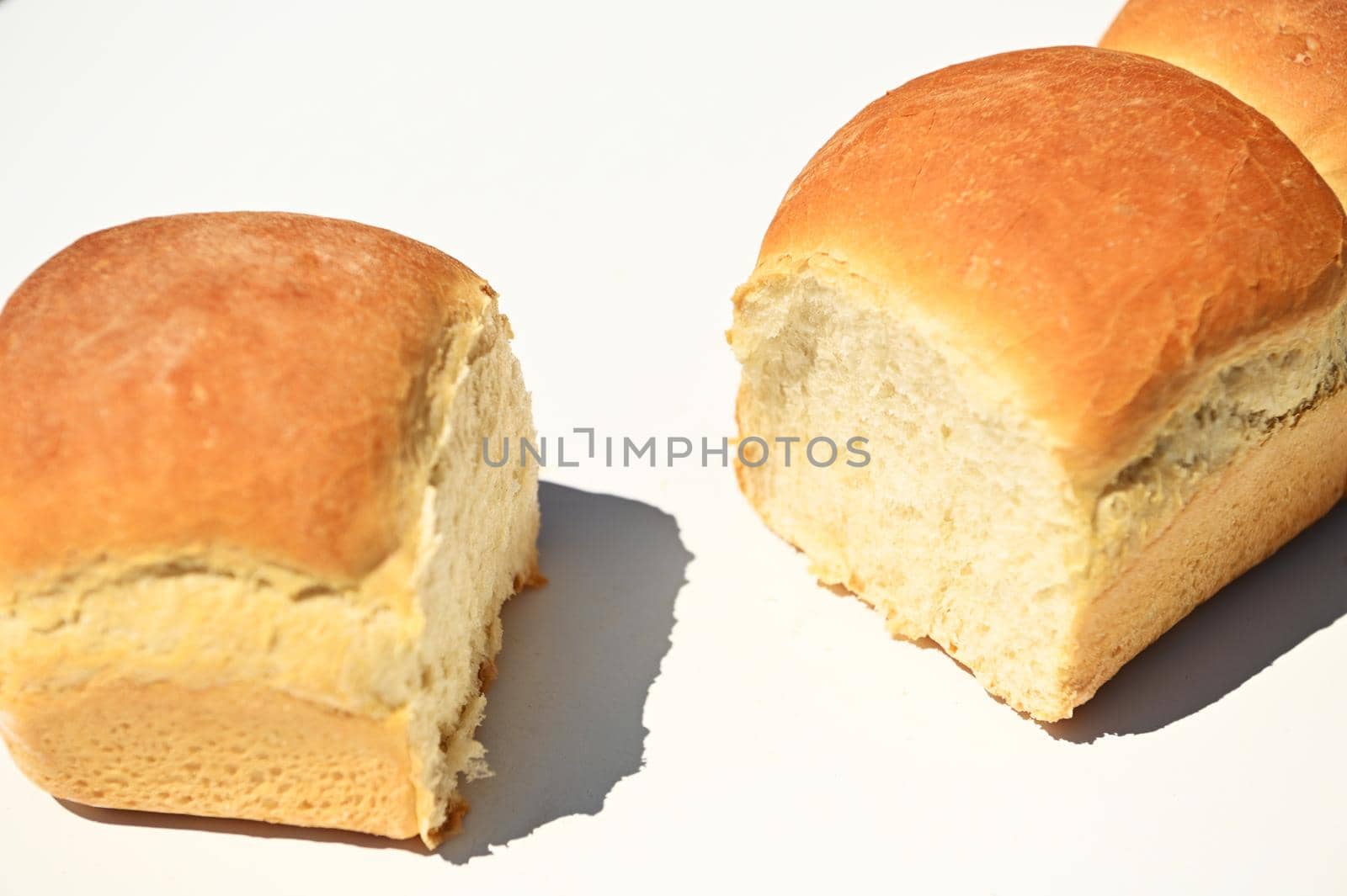 Close-up. Food composition of a fresh baked whole grain buns on a white background with copy ad space for advertising text.