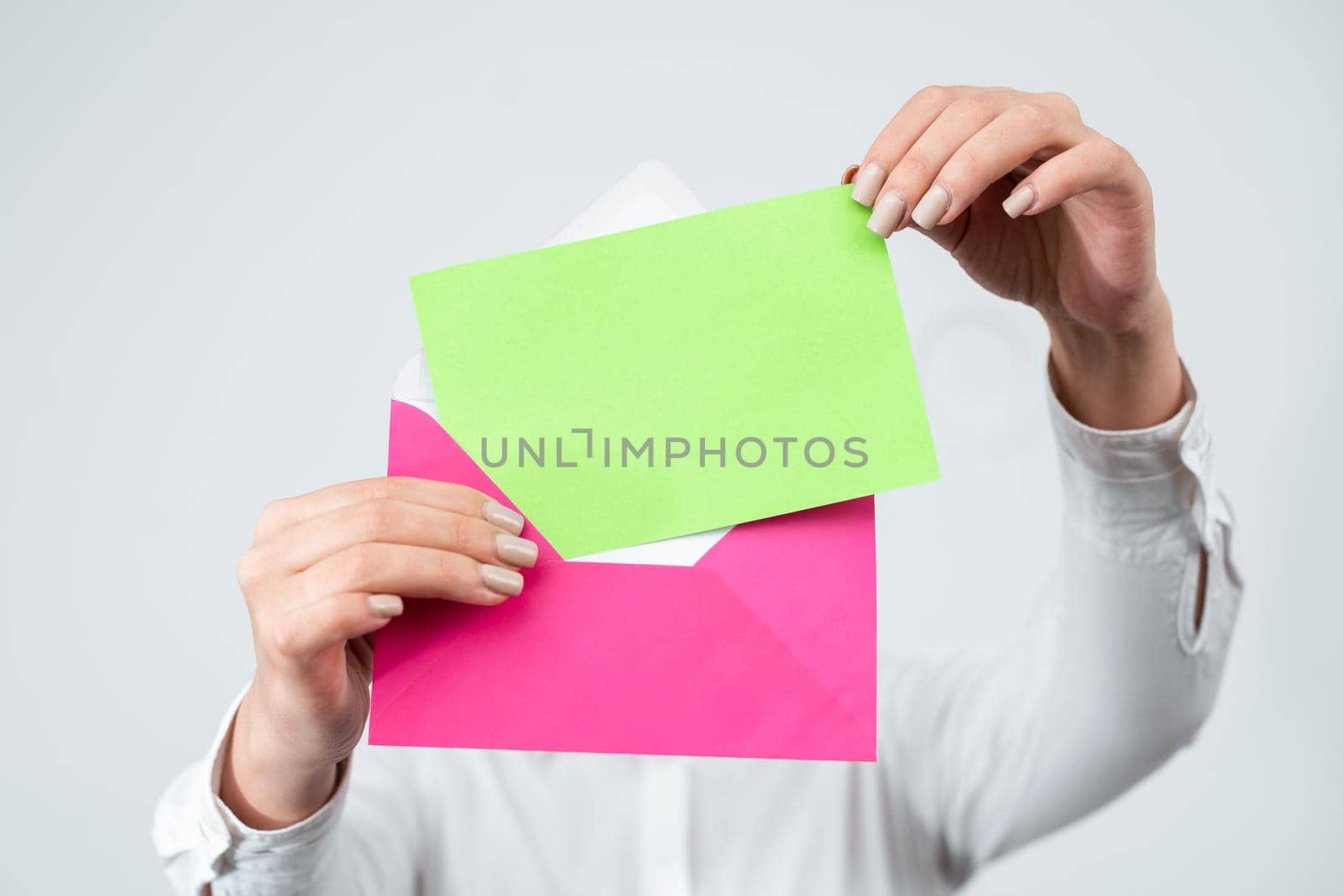 Hands Of Female Professional Putting Letter With Crucial Message In Envelope. Businesswoman Having Document In Hands Sending Important Information Through Post. by nialowwa