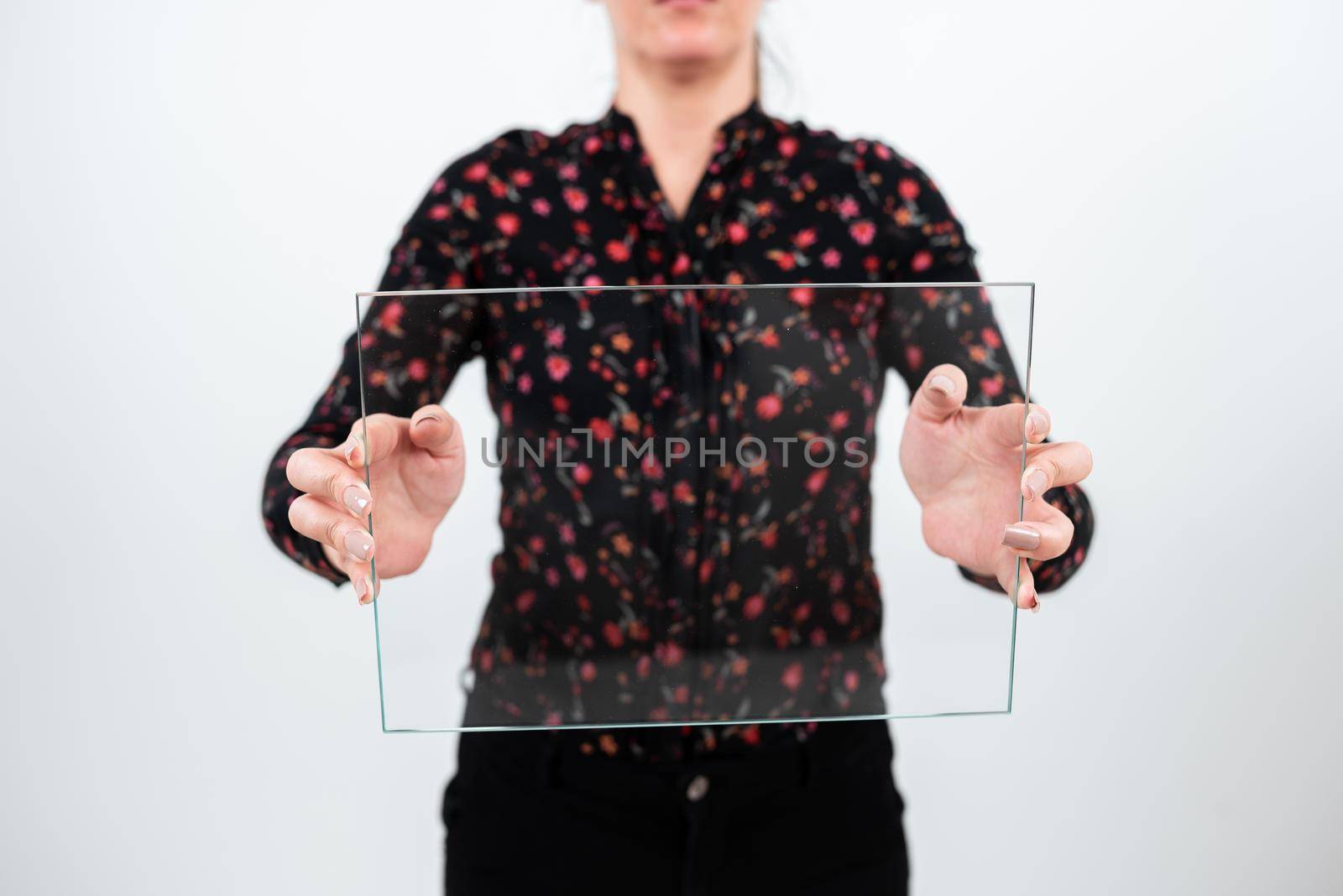 Female Professional Wearing Floral T-Shirt Holding Transparent Glass And Displaying Important Sales Data. Woman With Rectangular Banner Promoting The Company Brand. by nialowwa