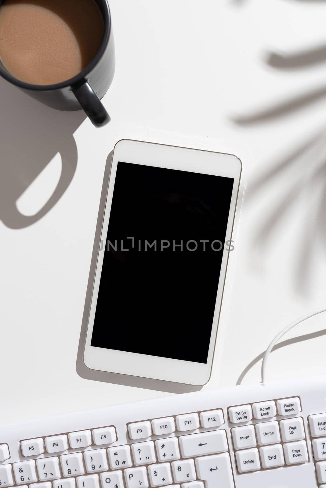 Mobile Phone Screen With Important Message On Desk With Coffee And Keyboard