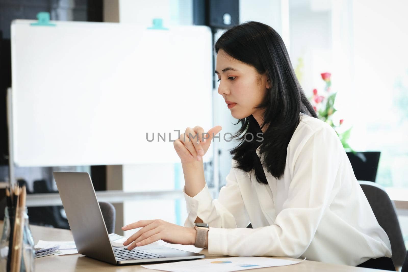 Female employees are working at home through computers to maintain social distancing to reduce the spread of coronavirus