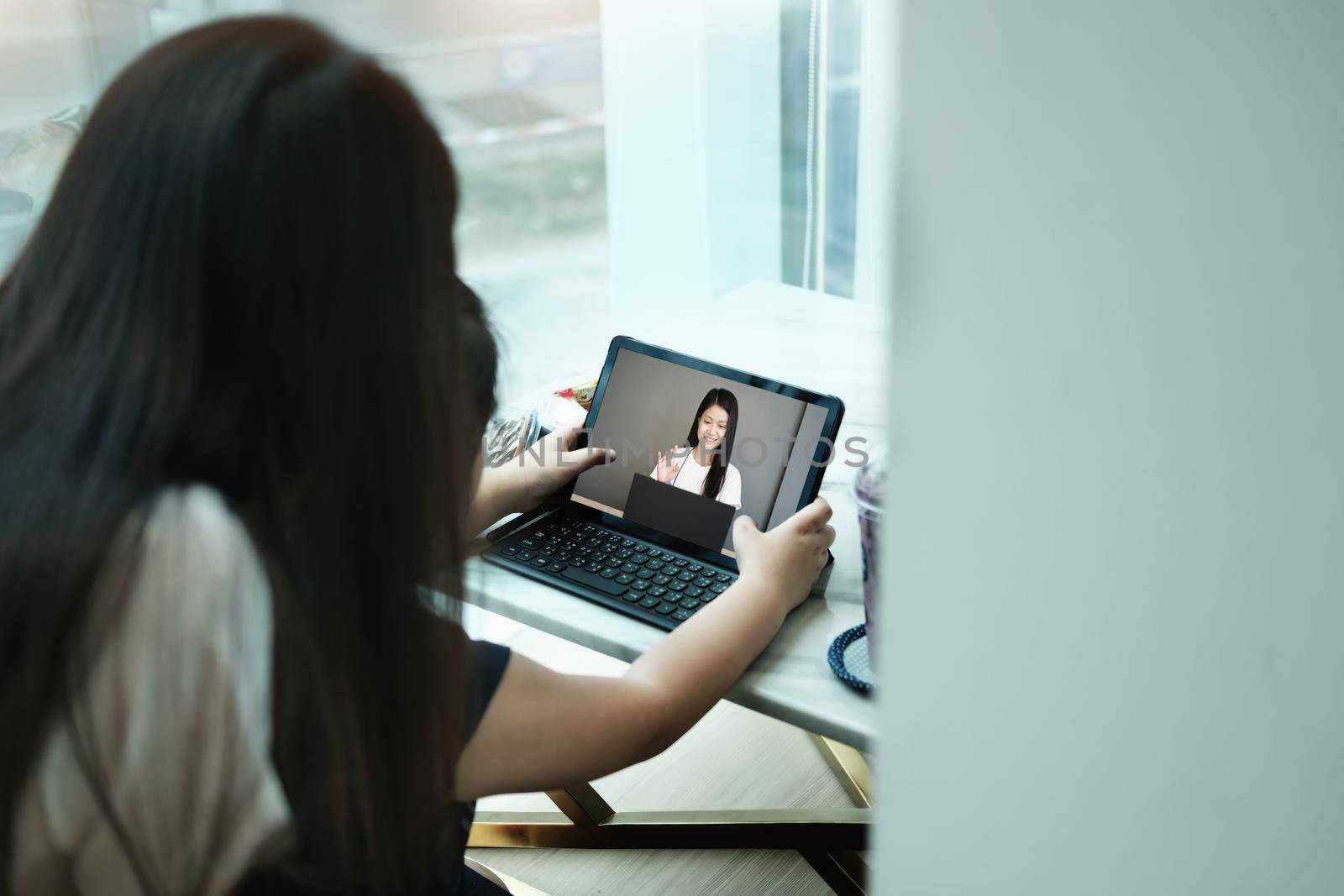 E-learning ,online education and internet social distancing protect from COVID-19 viruses concept. Asian children student video conference e-learning with teacher on tablet computer at home