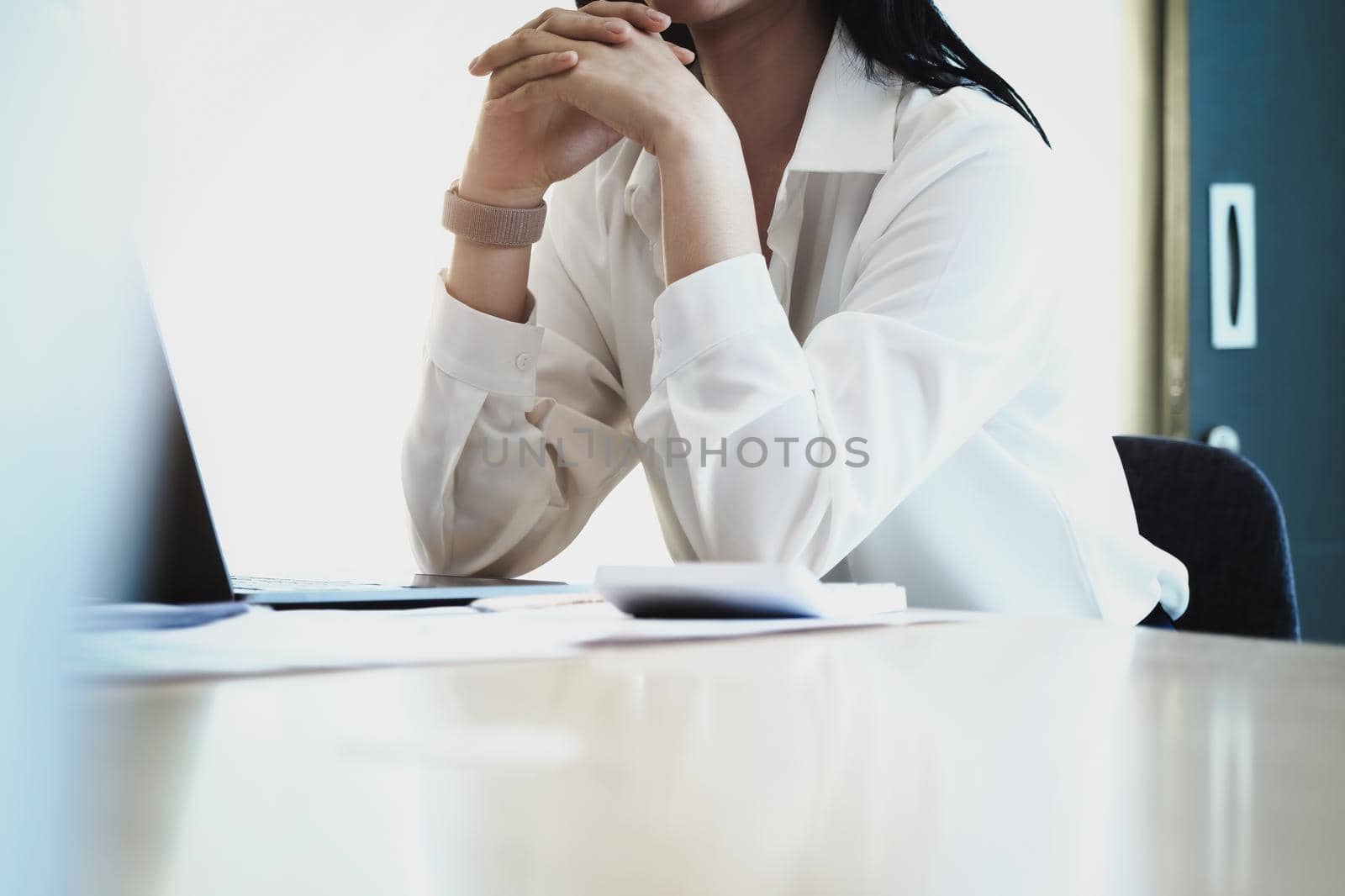 Female employees are working at home through computers to maintain social distancing to reduce the spread of coronavirus. by Manastrong