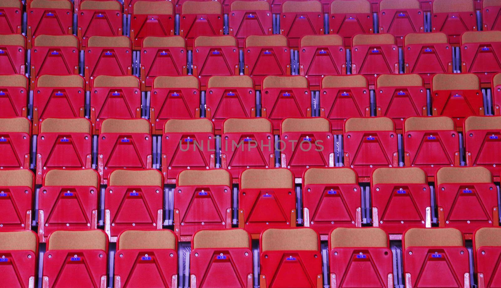 Rows of red football stadium seats with numbers. by gelog67