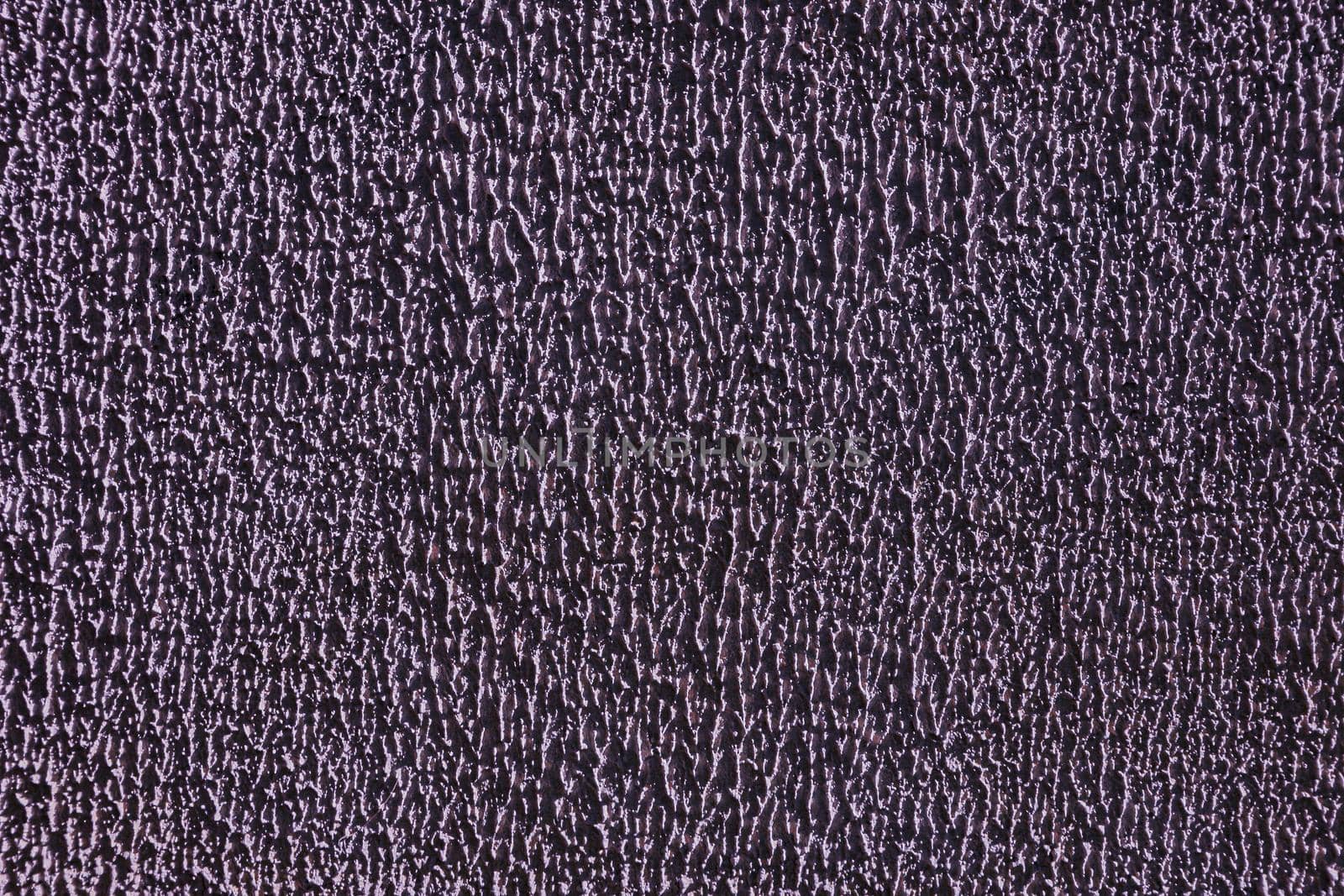 Relief shabby purple wall. The old rough surface of the wall .