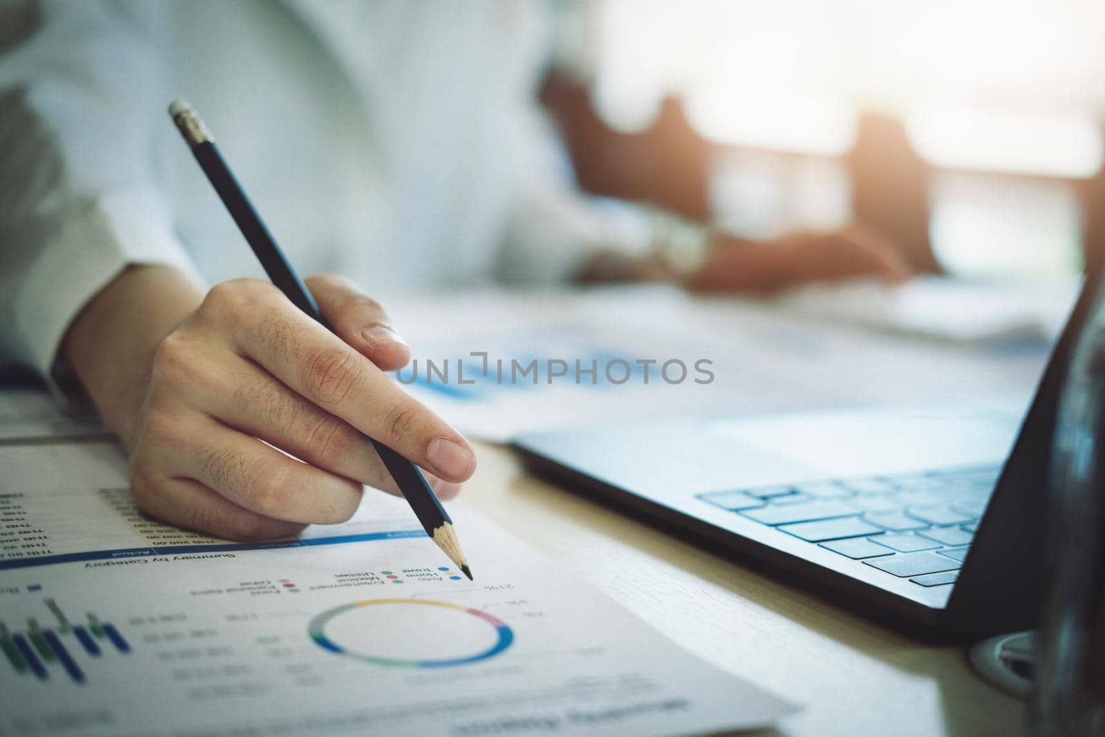 focus woman holding a pencil Auditors use budget document calculators to find annual budget disbursement errors. by Manastrong